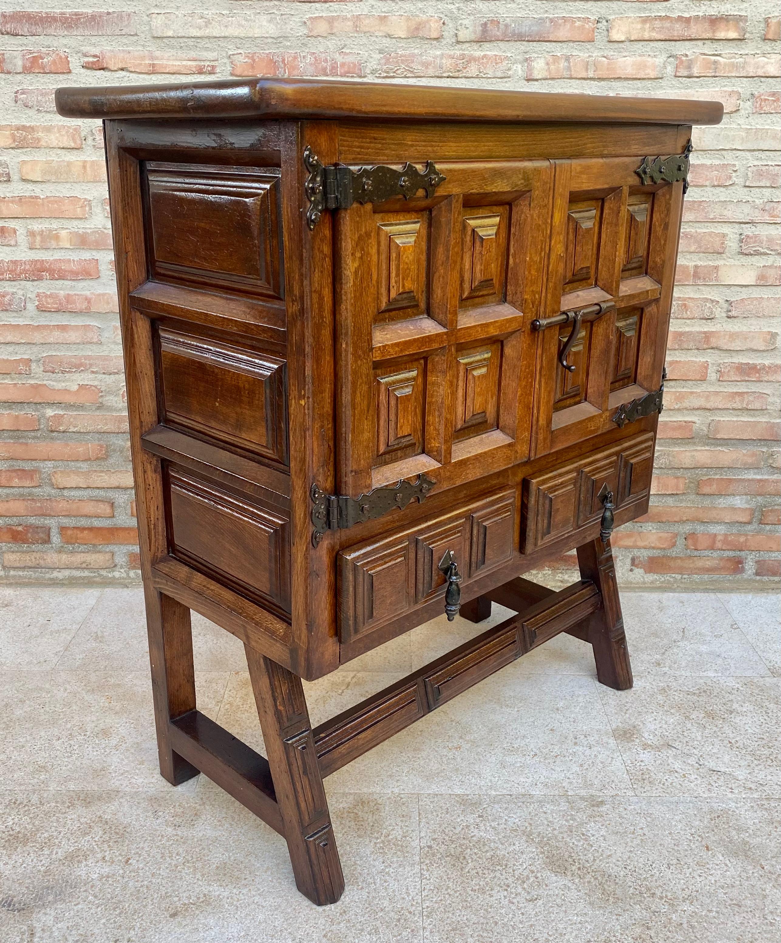 19th Catalan Spanish Baroque carved walnut Tuscan two drawers chest of drawers.

From the north of Spain, built in solid walnut, the rectangular top with a molded edge on a box that fits into two solid walnut paneled doors, two drawers in the lower