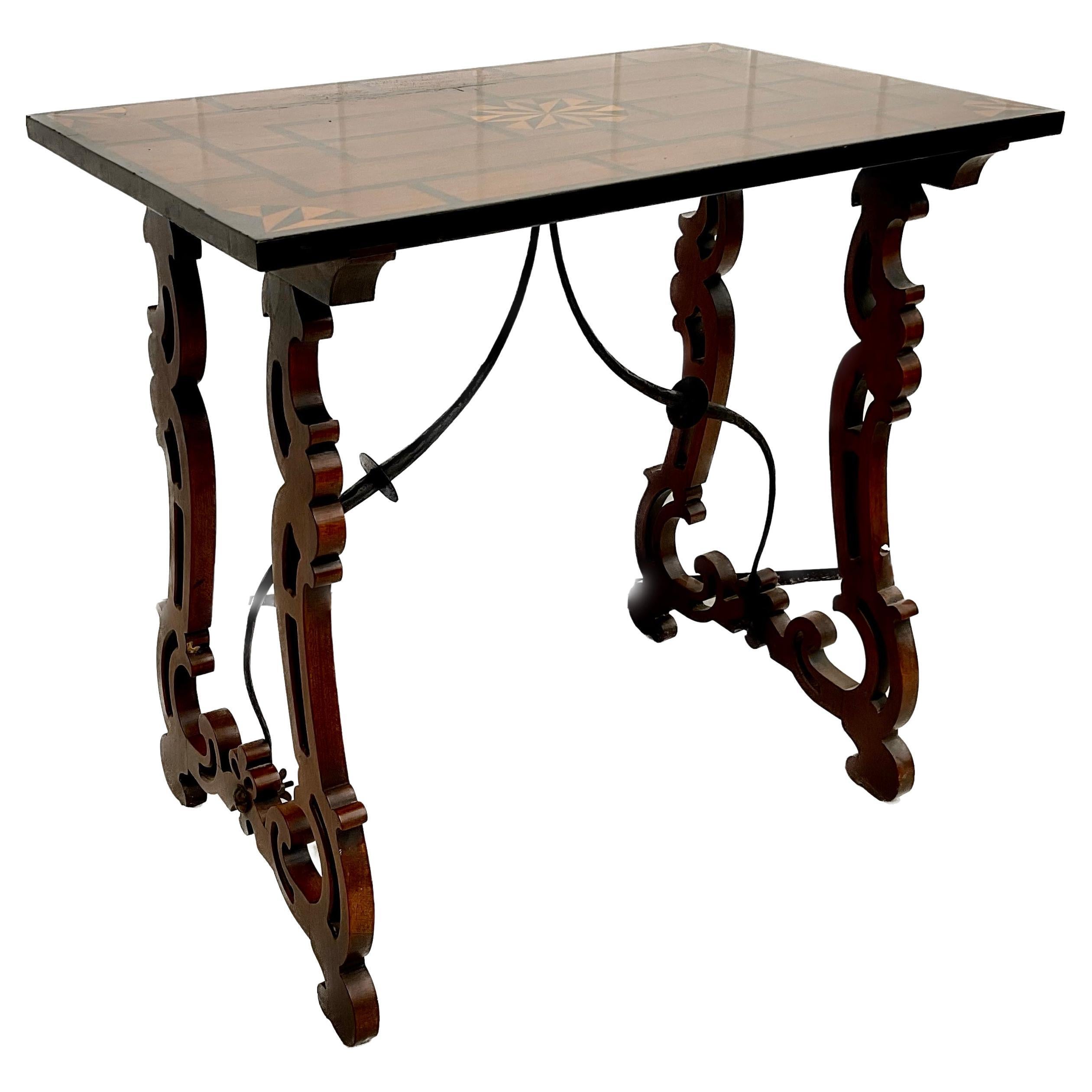 Inlaid Spanish Baroque trestle side table, the surface having geometric pattern marquetry & central medallion. With pierced lyre form legs joined by iron stretcher. 