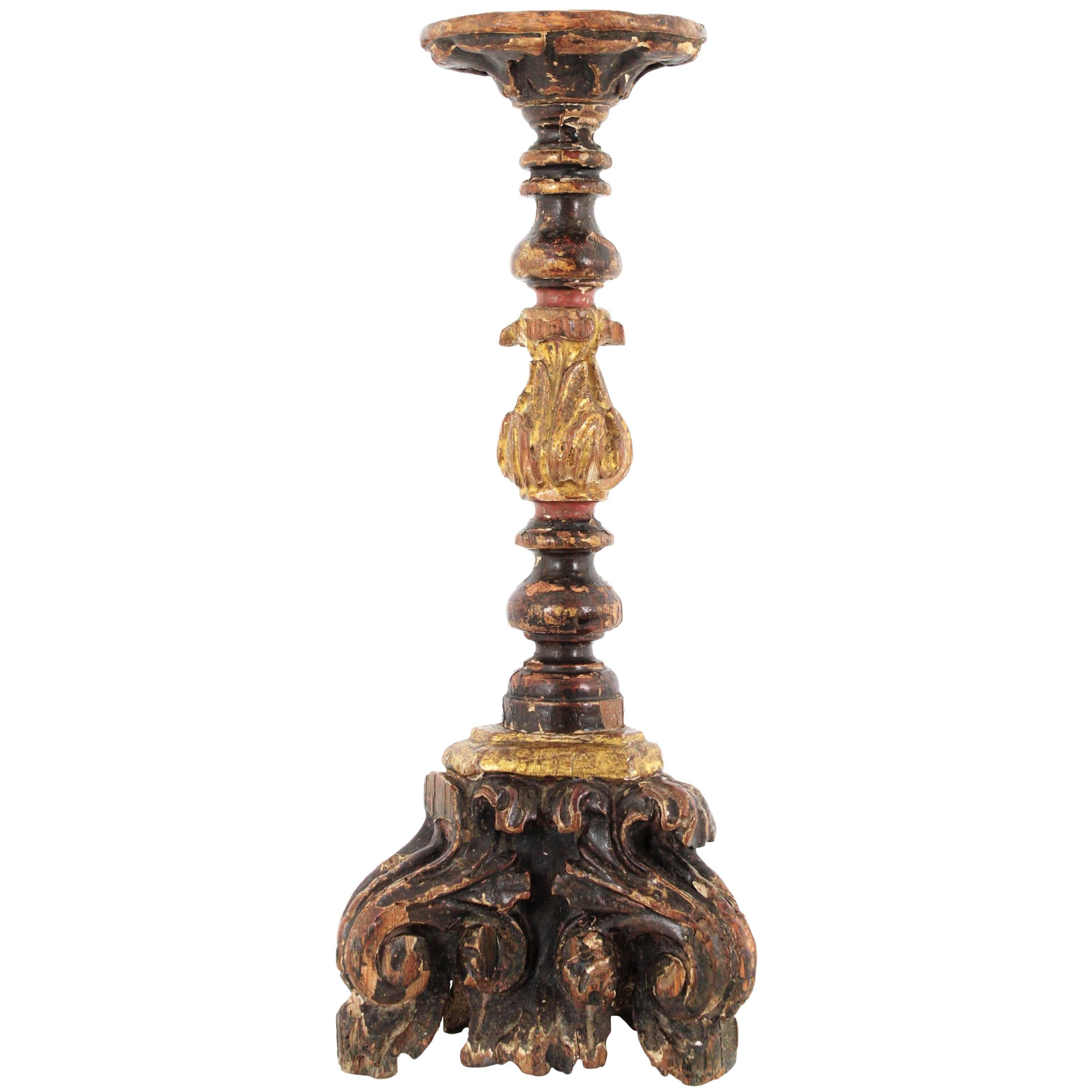 A finely carved late 18th century Baroque style candlestick with gilt and polichrome details, Spain, circa 1780.
This beautiful handcrafted candleholder with hand painted details in warm colors has gold leaf finish and a terrific antique