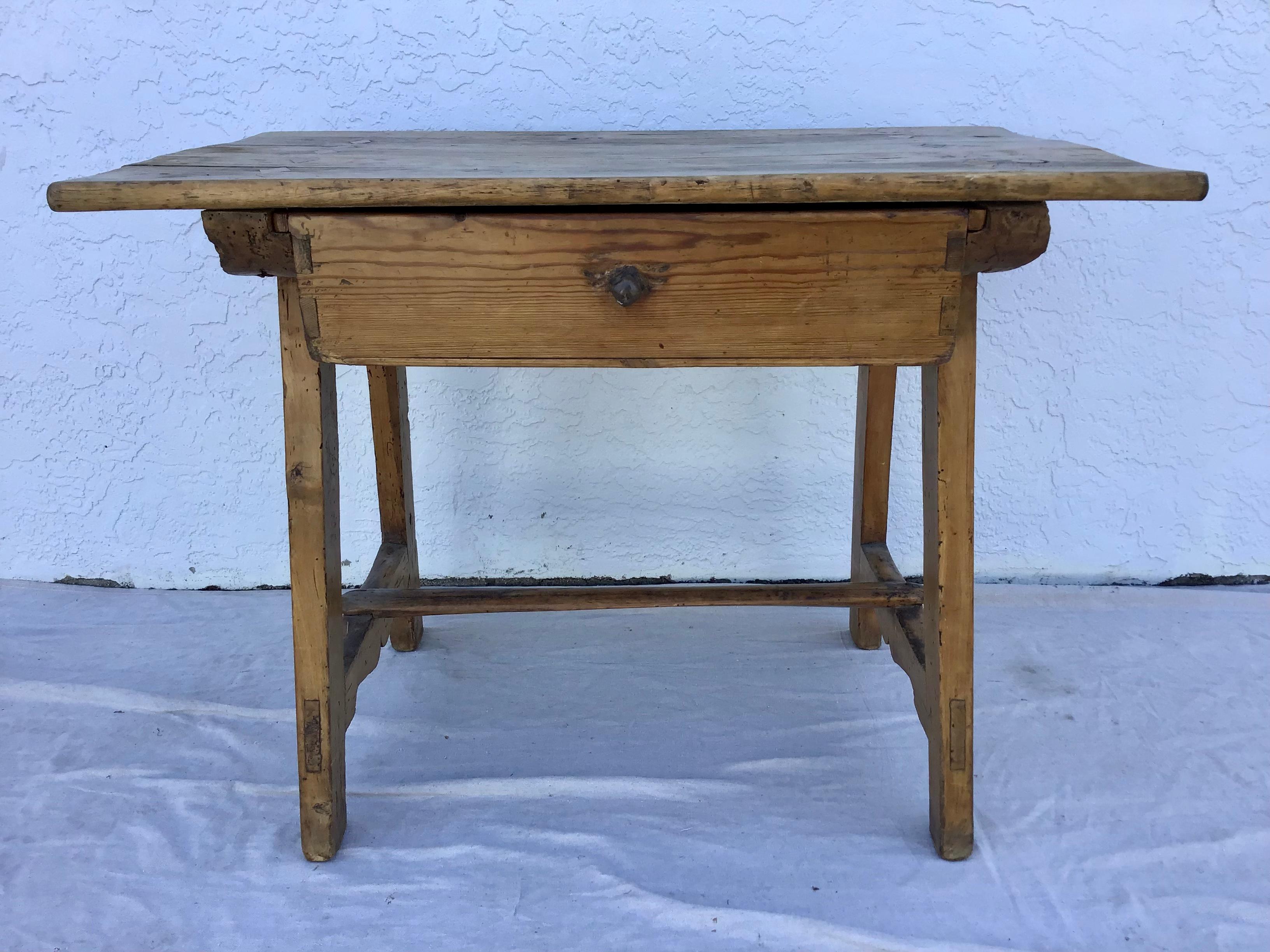A superb Spanish Colonial one-drawer sabino wood hacienda table, 18th century. Having a rectangular top supported by trestle-form legs, the drawer suspended from below the top, the legs joined by a simple stretcher. Wonderful old wear and patina.