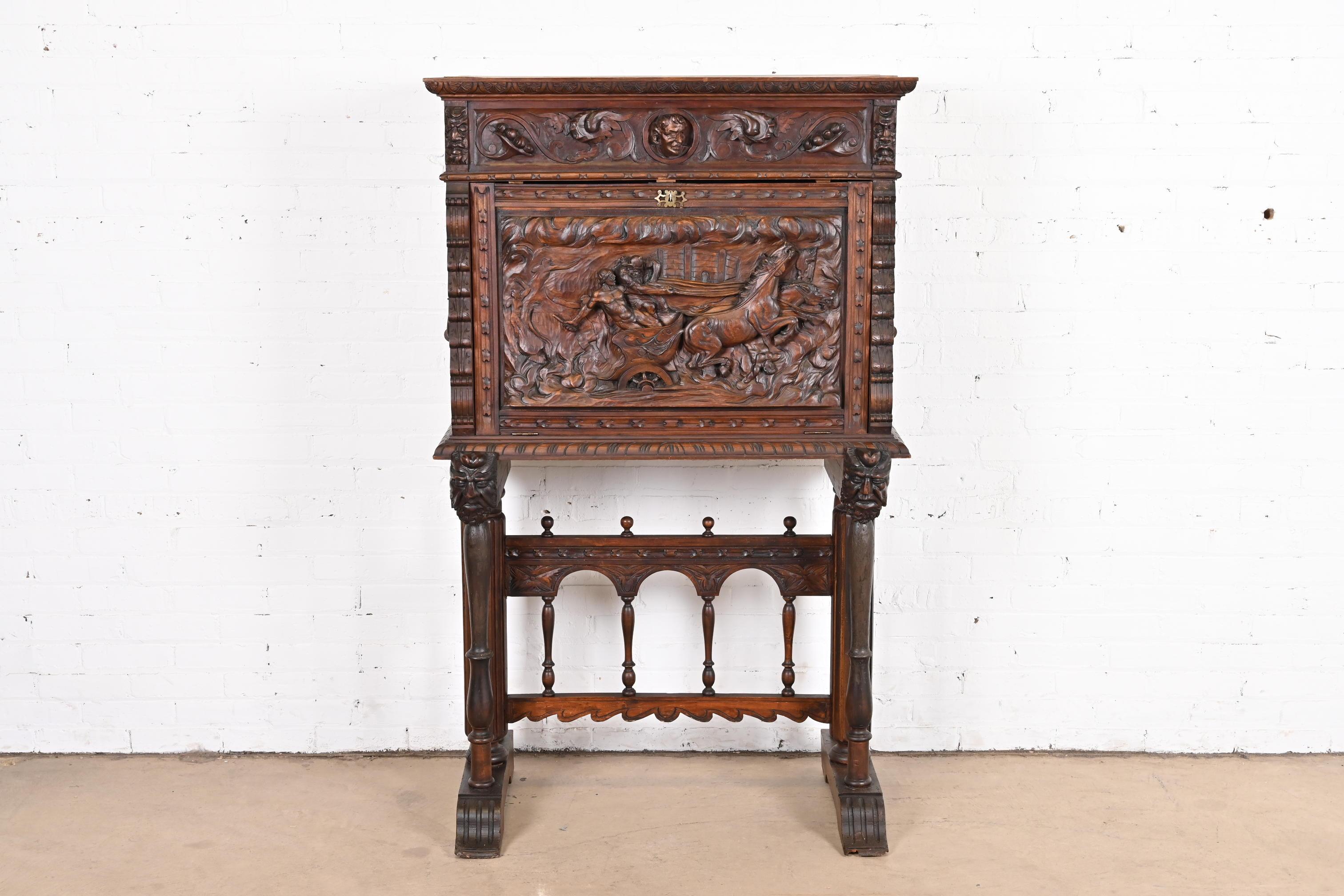 An outstanding antique Spanish Baroque Renaissance drop front desk or bar cabinet on stand

Spain, Late 19th century

Ornate carved walnut, with carved faces and horse and chariot with riders, and original iron hardware.

Measures: 37.25