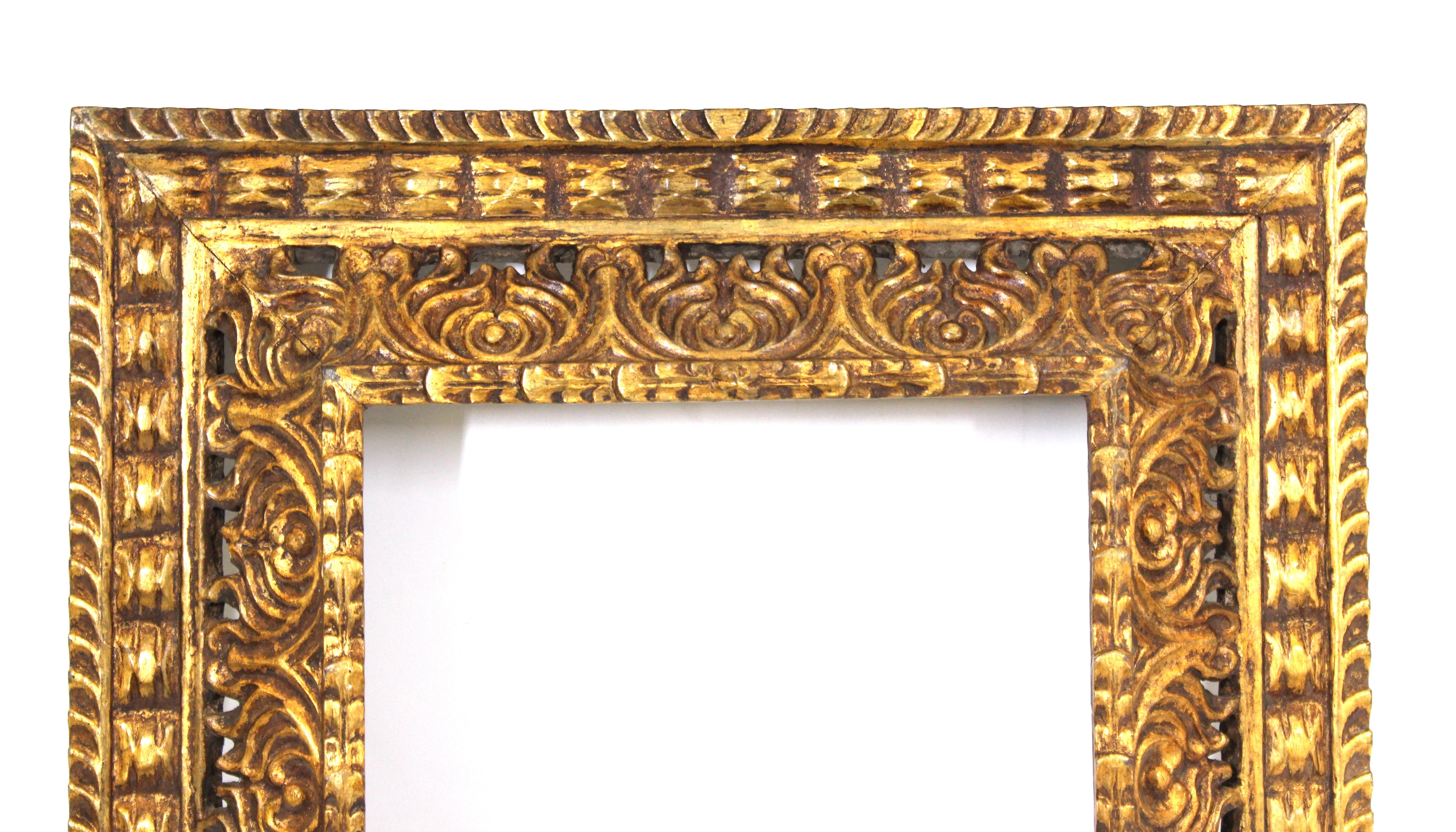Spanish Baroque Revival period picture frame in ornate carved giltwood. The piece was made in Spain in the 19th century and is in great antique condition with age-appropriate wear and desirable patina.