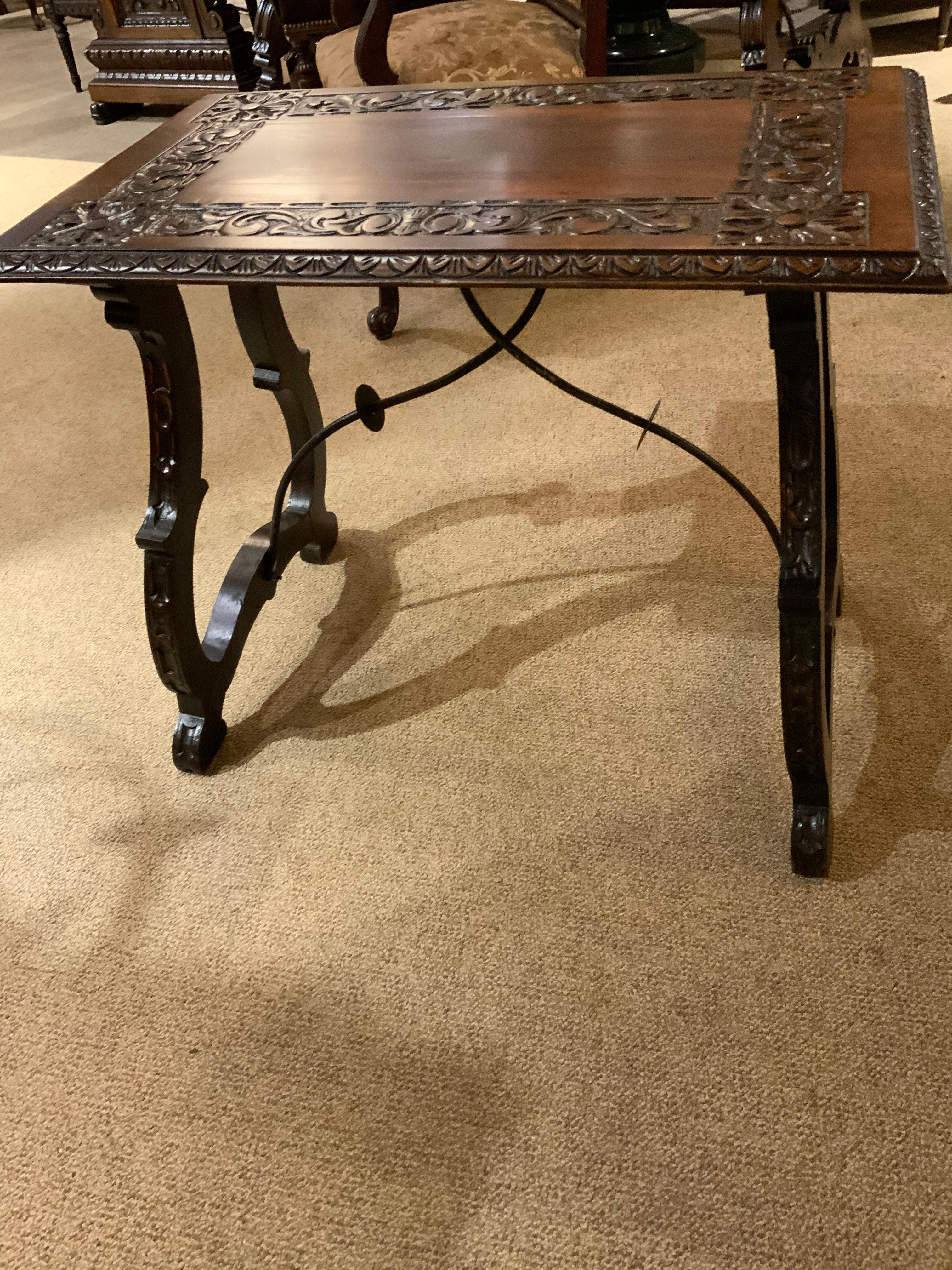 Spanish side table or occasional table with exceptional carving
Enhances the rustic beauty of this piece. The top is carved
With a geometric pattern on all four corners. More carving
Surrounds the four sides. The legs are curved and have 
Carved