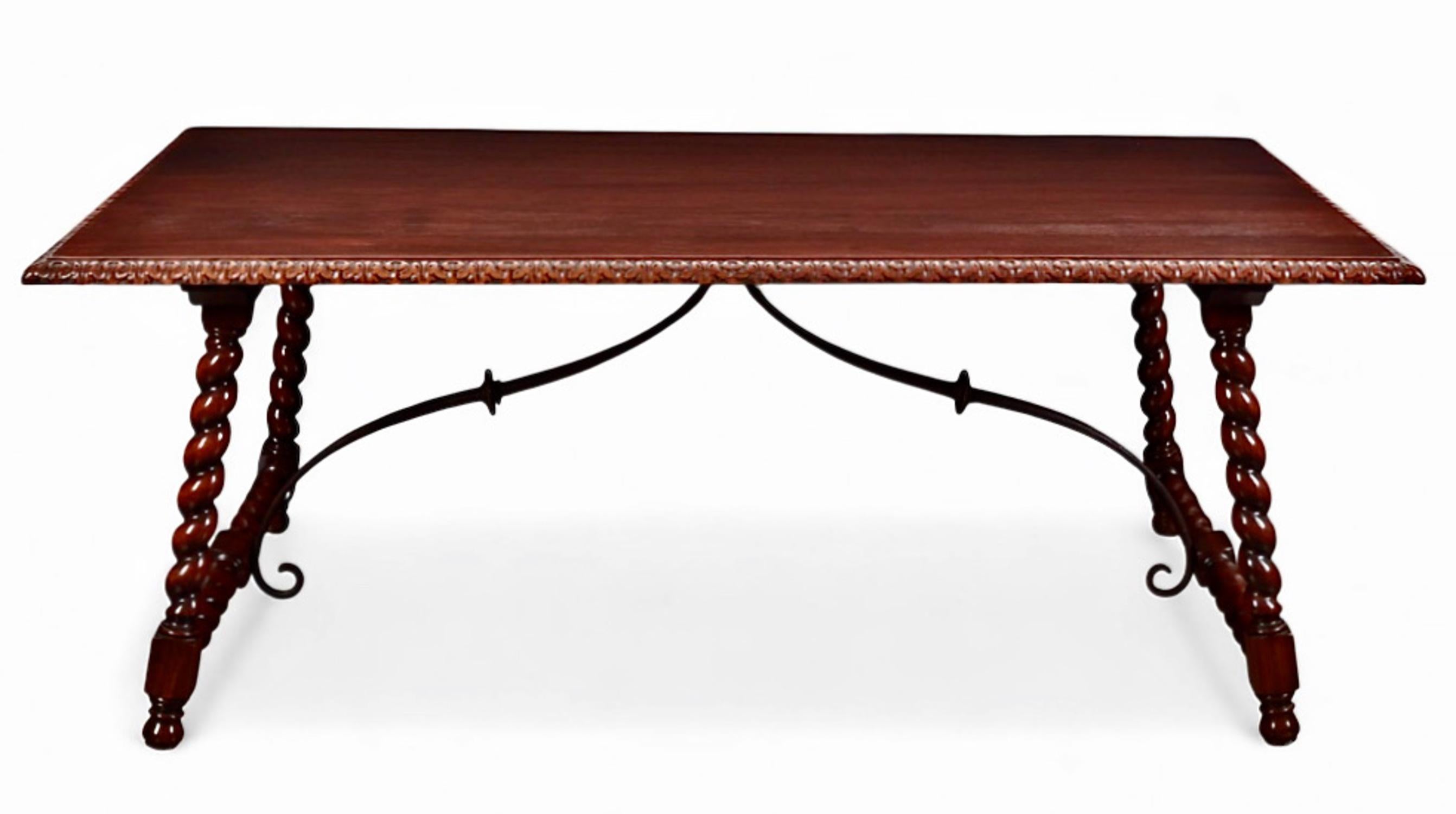 This a wonderful Spanish Baroque-Style mahogany table that can serve multi-purpose setting. The generous nearly 77' width allow it to be either the perfect library table or dining table. The gorgeous barley twist legs and forged iron stretcher