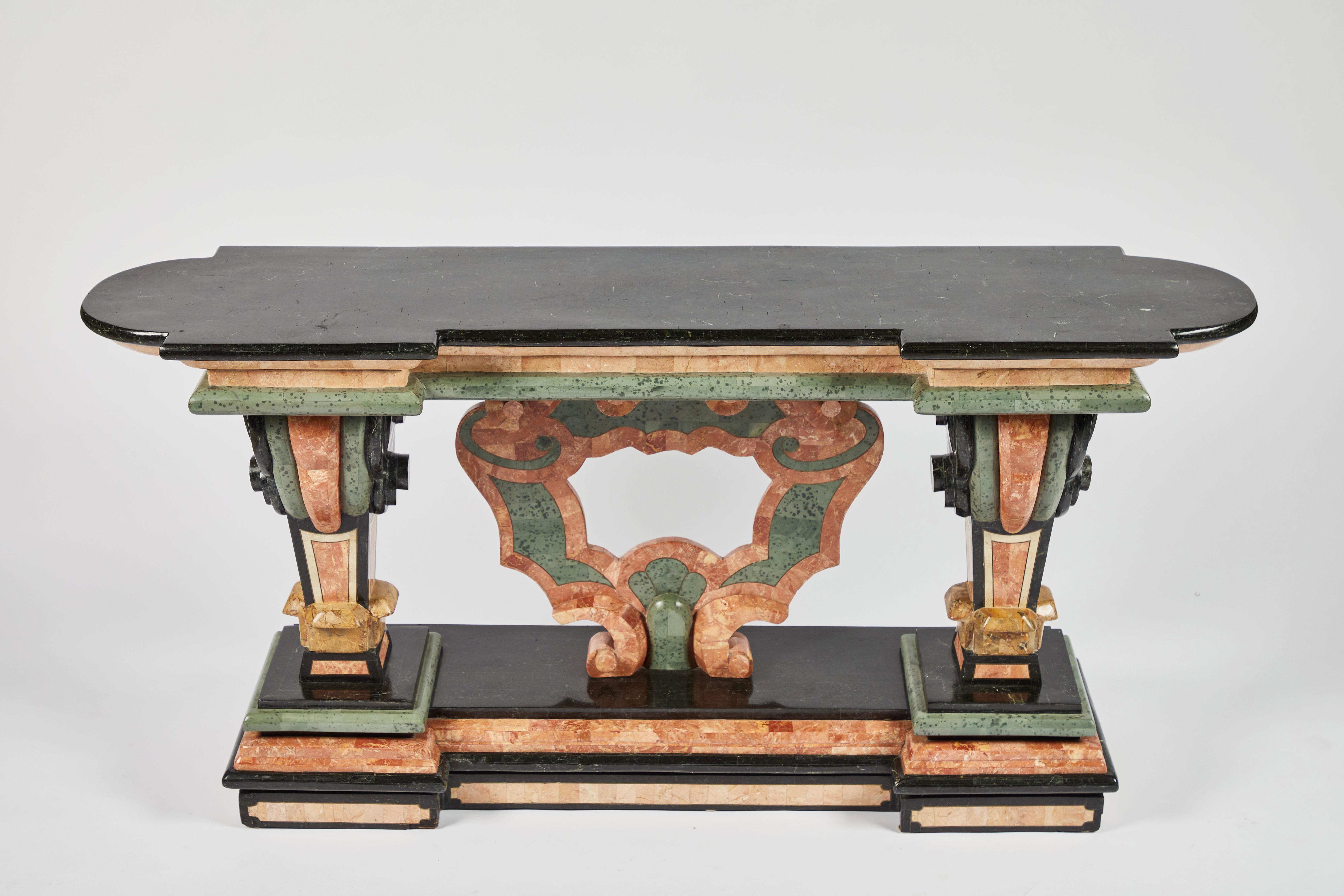 A stunning Spanish Baroque style marble veneered console table.
Antique Baroque style console table with a black marble shaped top supported by tapered columns culminating in scroll motif flanking a central urn-shaped frame, all resting upon a