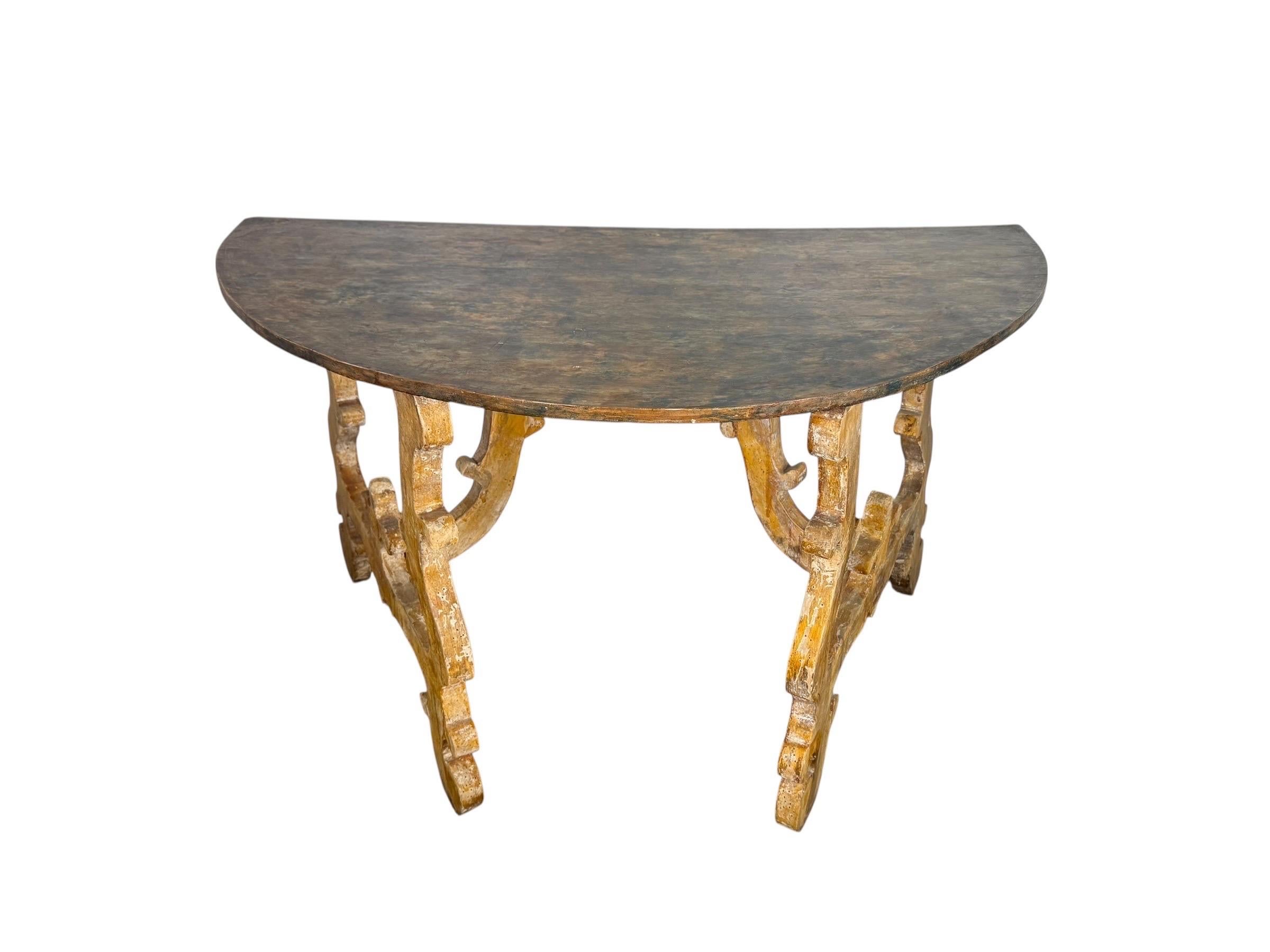 An 18th century style Spanish Baroque console table with a demi-lune top and bold carved base. The top is crafted in a thick, hand-planed wood plank, retaining a deep, aged surface with beautiful wear and patination.

The base features exuberantly