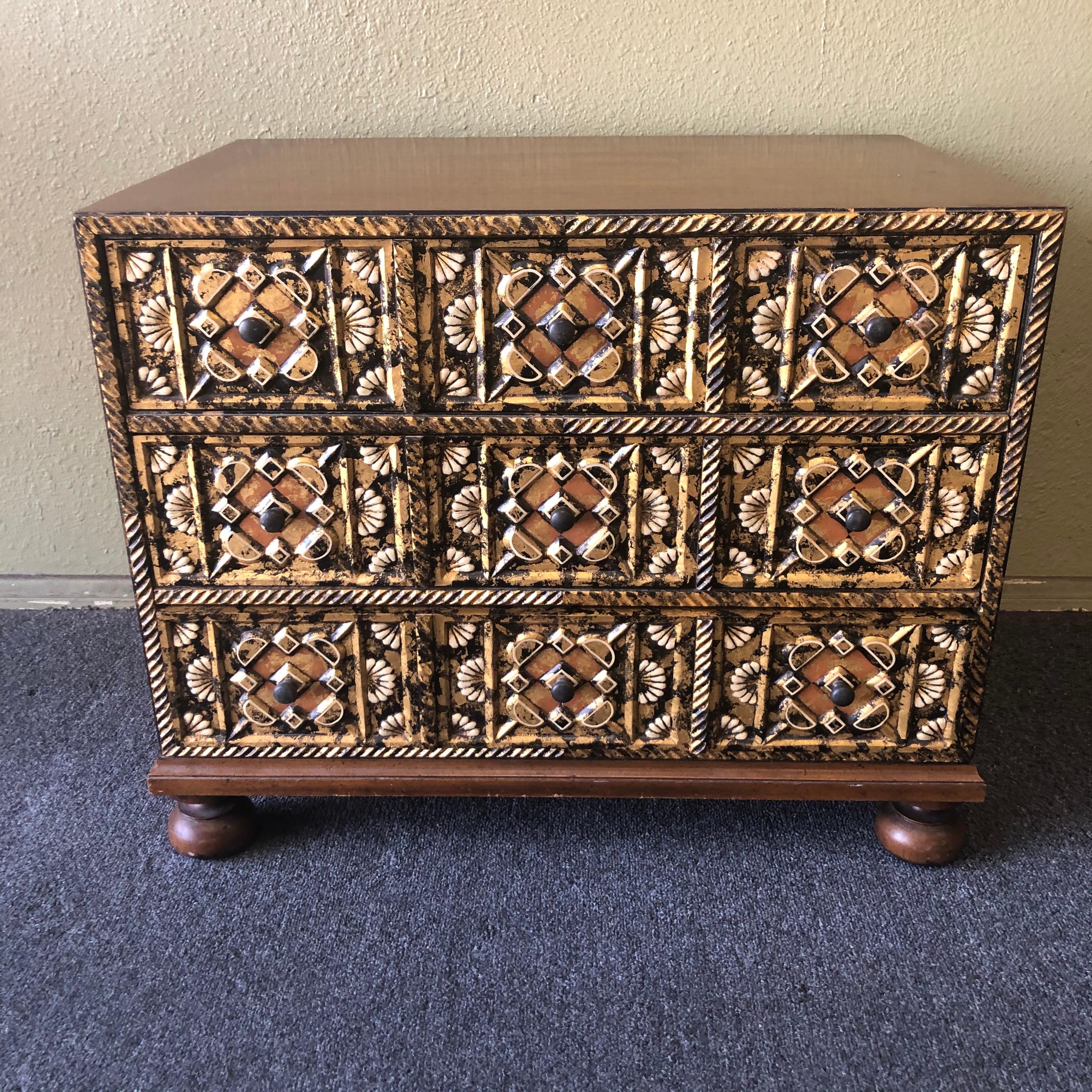 Spanish Baroque style three drawer chest by John Widdicomb, circa 1980s. This small dresser, with its romantic and ornately painted floral facade has a simple frame that is beautifully detailed with ornately painted, gilt and carved front with fans