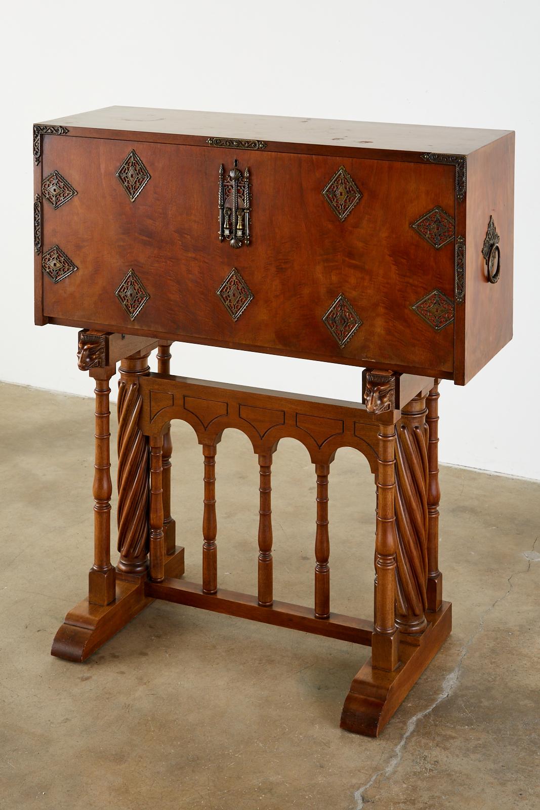 Exceptional late 19th century Spanish vargueño cabinet desk or chest on stand. Featuring a carved walnut case with brass metal strapwork, side handles, decorations, and lock plates. Also known as a bargueño or escritorio. This campaign style cabinet