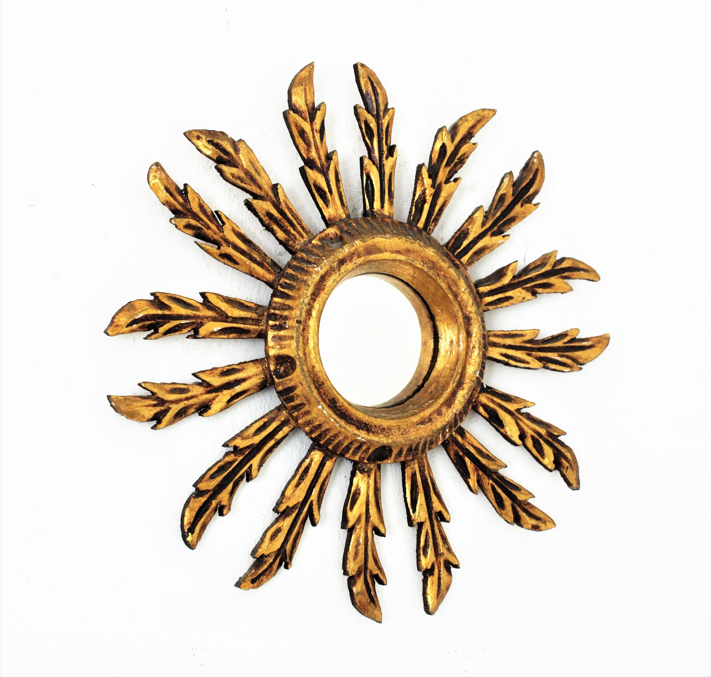 Early 20th century carved giltwood mini sized sunburst mirror in Baroque style.
Beautiful giltwood sunburst mirror in this unusual mini size.
Carved wood covered with gesso and gold leaf finish. Terrific aged patina.
To be placed alone or as a