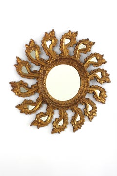 Specchio barocco spagnolo a raggiera in legno dorato con cornice intagliata a motivi vegetali, 1940