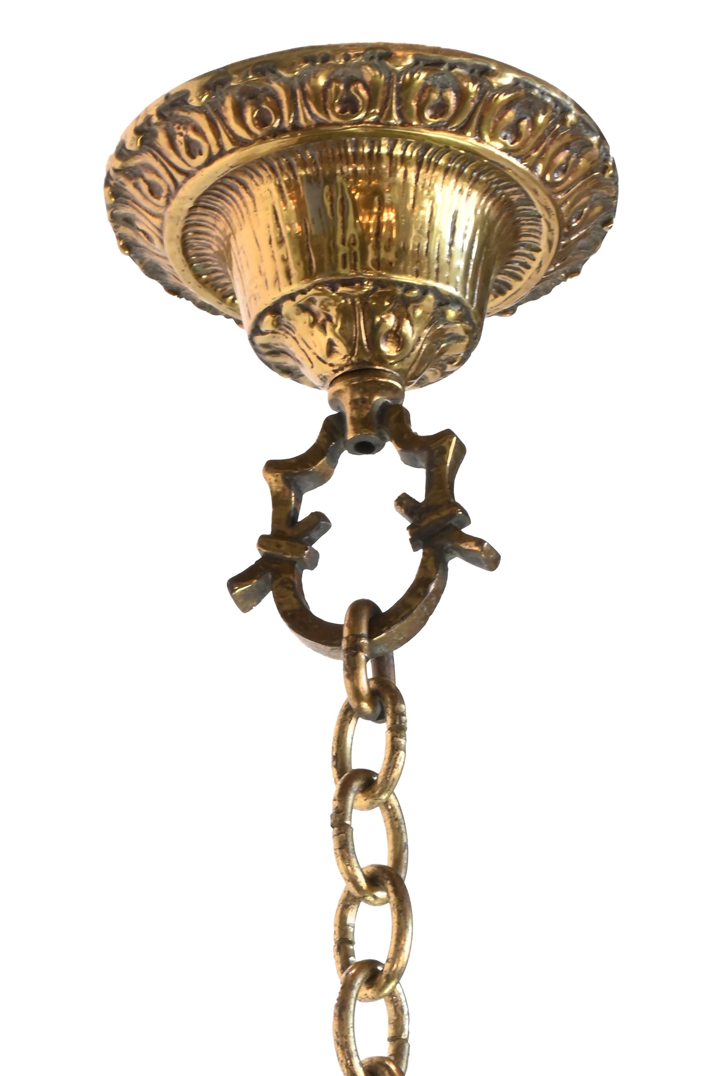 Details make Larger Scale Spanish Baroque or even Tudor Revival Brass Chandelier stand out. Created in the styling of Oscar Bach castings and plenty of illumination will be giving from this fixture. 

AA# 61065
Circa: 1930’s
Condition: Age