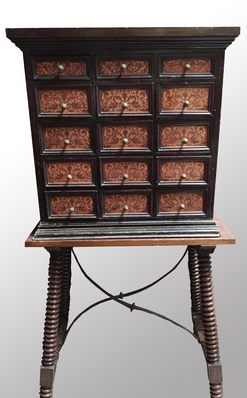 Beautiful 18th century Spanish Baroque seaweed inlaid Vargueno cabinet on later 19th century stand.
The moulded pediment is over fifteen fitted drawers, three small and twelve large drawers, inlaid with seaweed in a foliage motif, raised on a