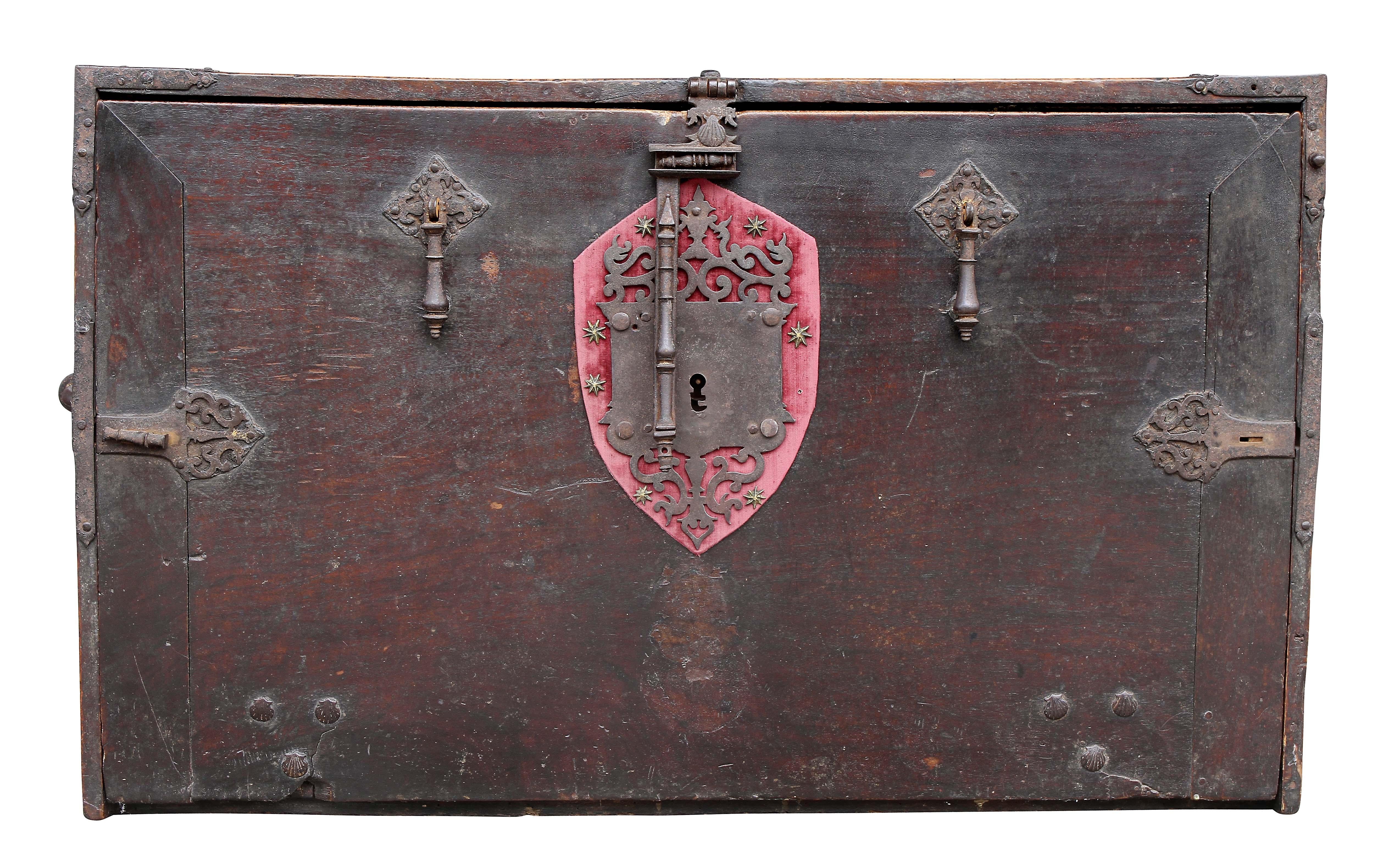 Lacking a base. With rectangular top with iron strapping over a fold down writing lid exposing a fitted painted and gilded interior with drawers and doors. Side carrying handles. Pierced lock plate over a velvet panel.