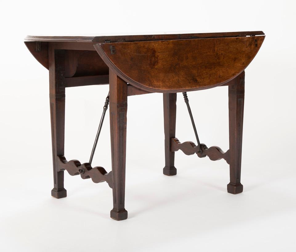 Hand-Carved Spanish Baroque Walnut Drop Leaf Table with Wrought Iron Stretchers For Sale