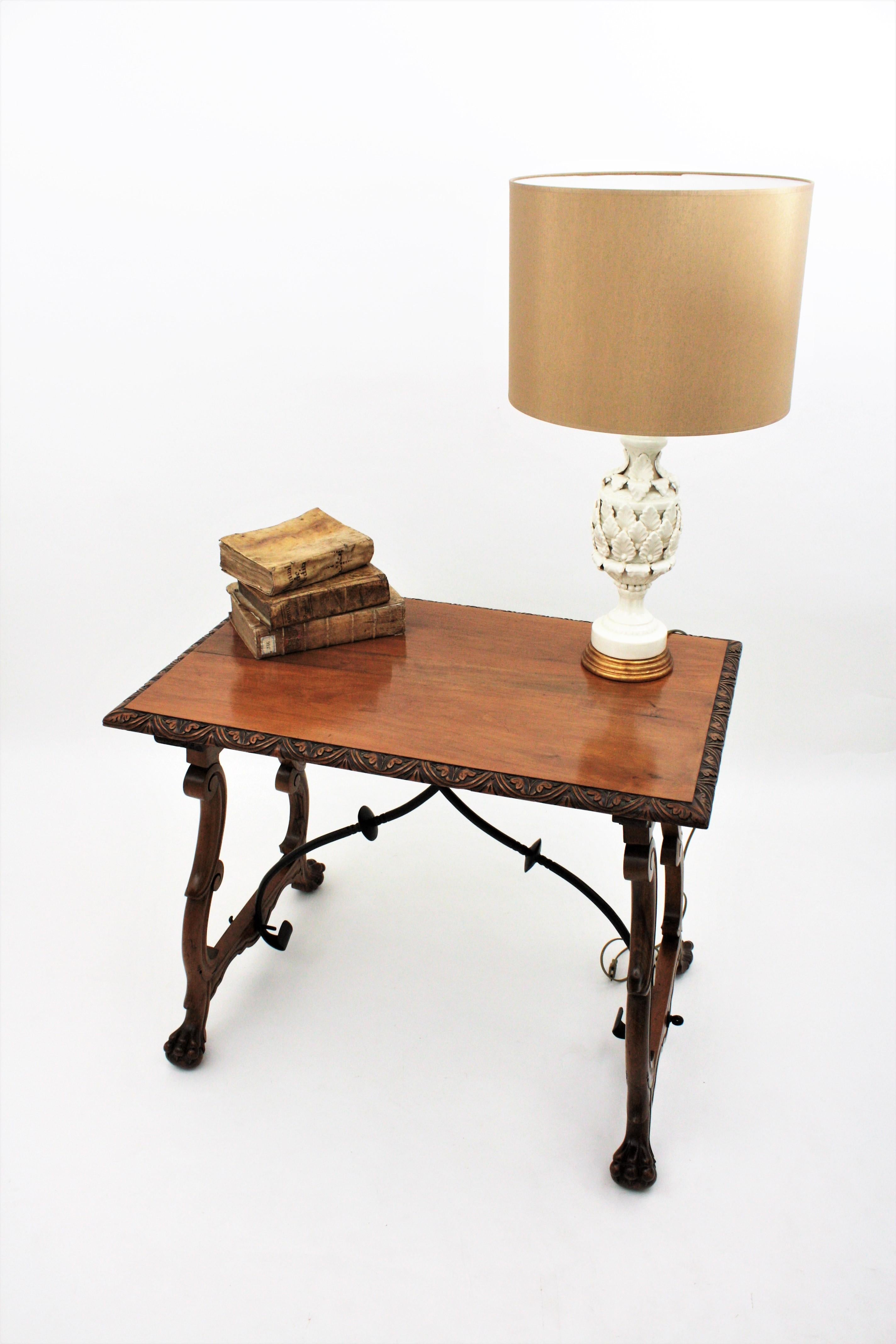 Spanish Colonial Baroque walnut lyre-leg fratino table with iron stretcher
Exquisite antique hand carved lyre-leg walnut wood Fratino trestle table with iron stretchers.
This gorgeous Fratino table features a rectangular top with beautifully carved
