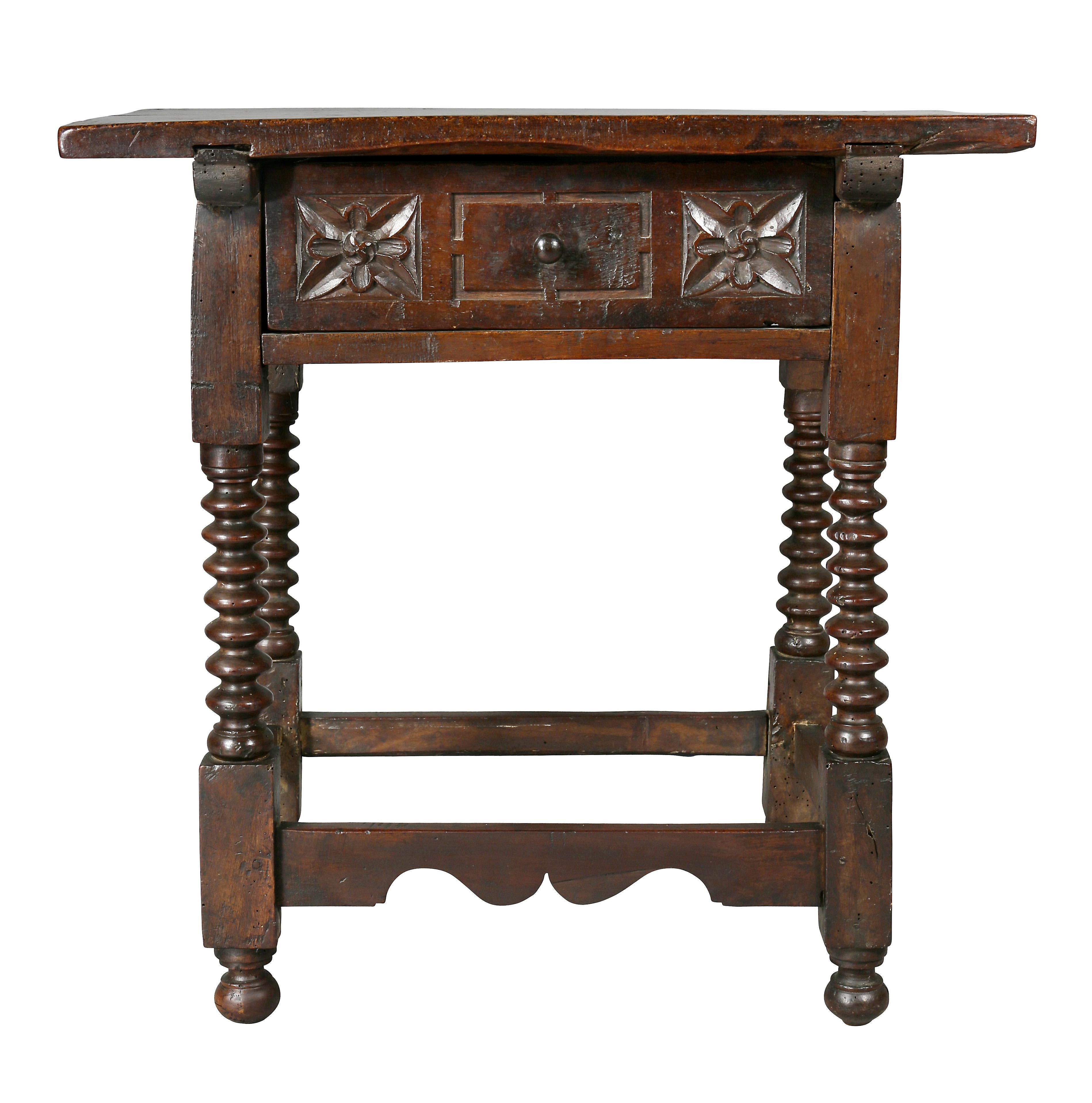 Rectangular top over a chip carved drawer raised on ring turned legs joined by a box stretcher.