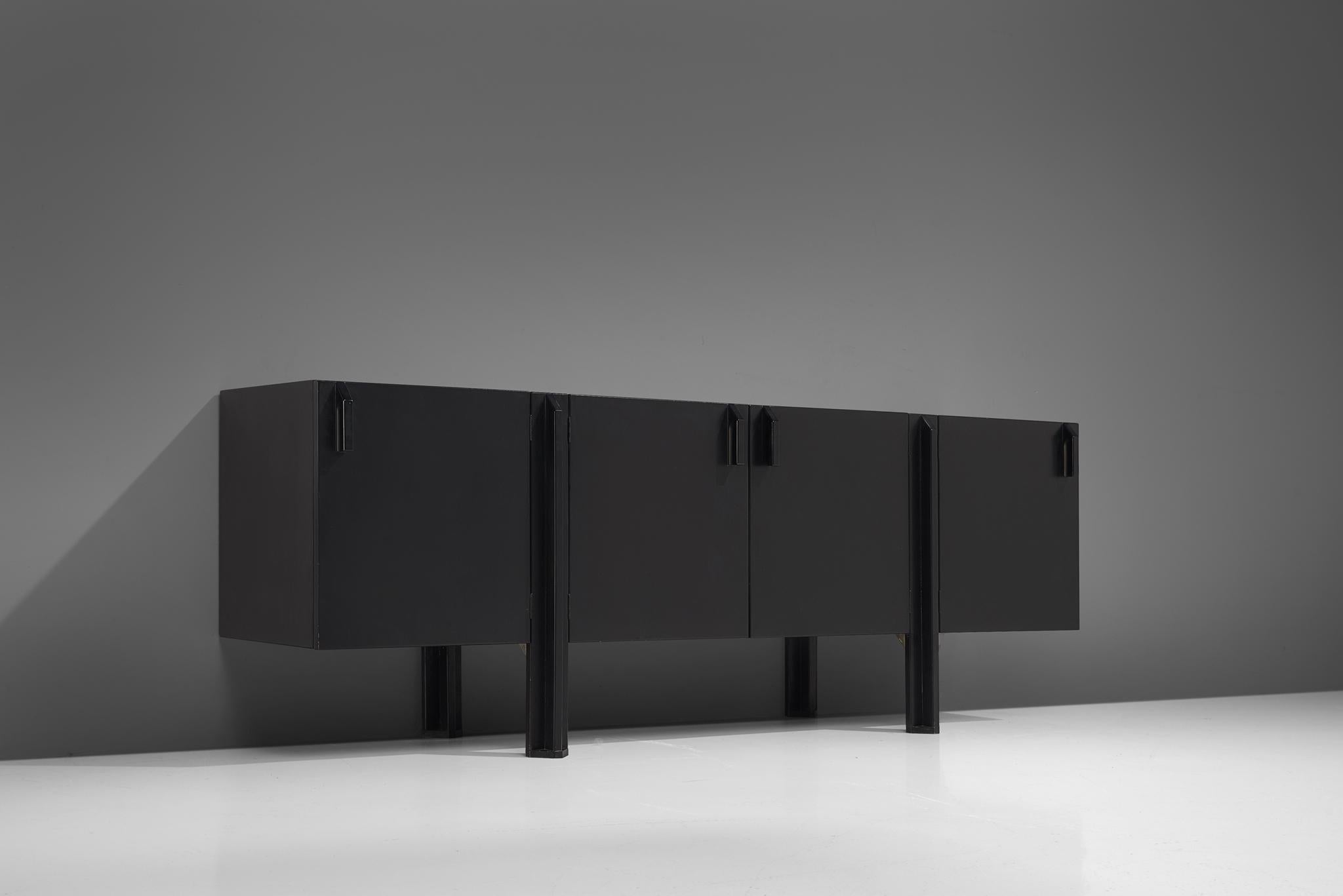 José Martínez-Medina, credenza, black lacquered wood, Spain, 1970-1980s.

This monumental, black satinatedsideboard consists out of three separate modules, divided over four doors. The doors feature sturdy, geometric handles. Lifted from the