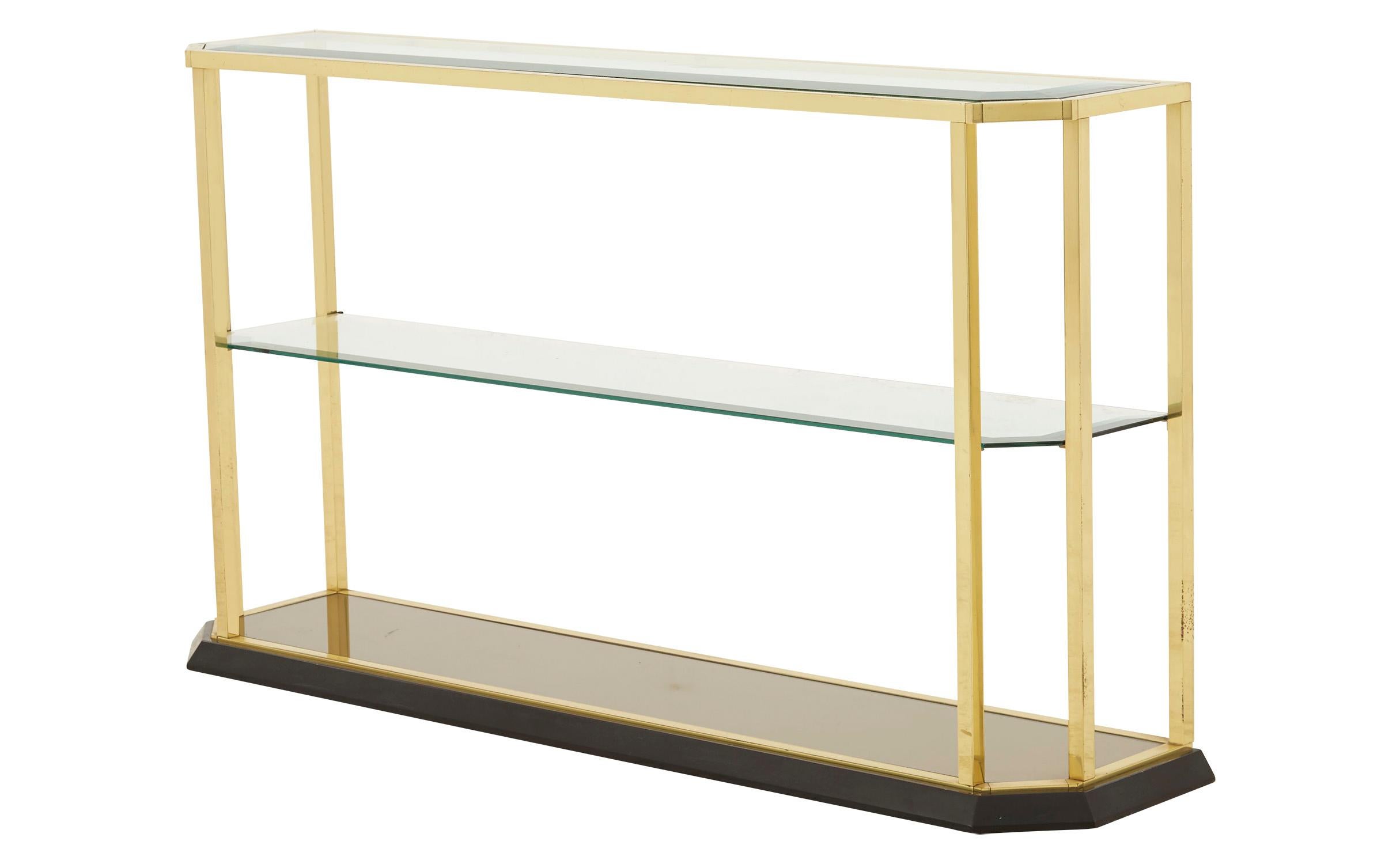 • Brass frame
• Black wood base
• Original beveled glass
• Mirrored bottom shelf
• 20th century
• Spain
• Measures 53.5