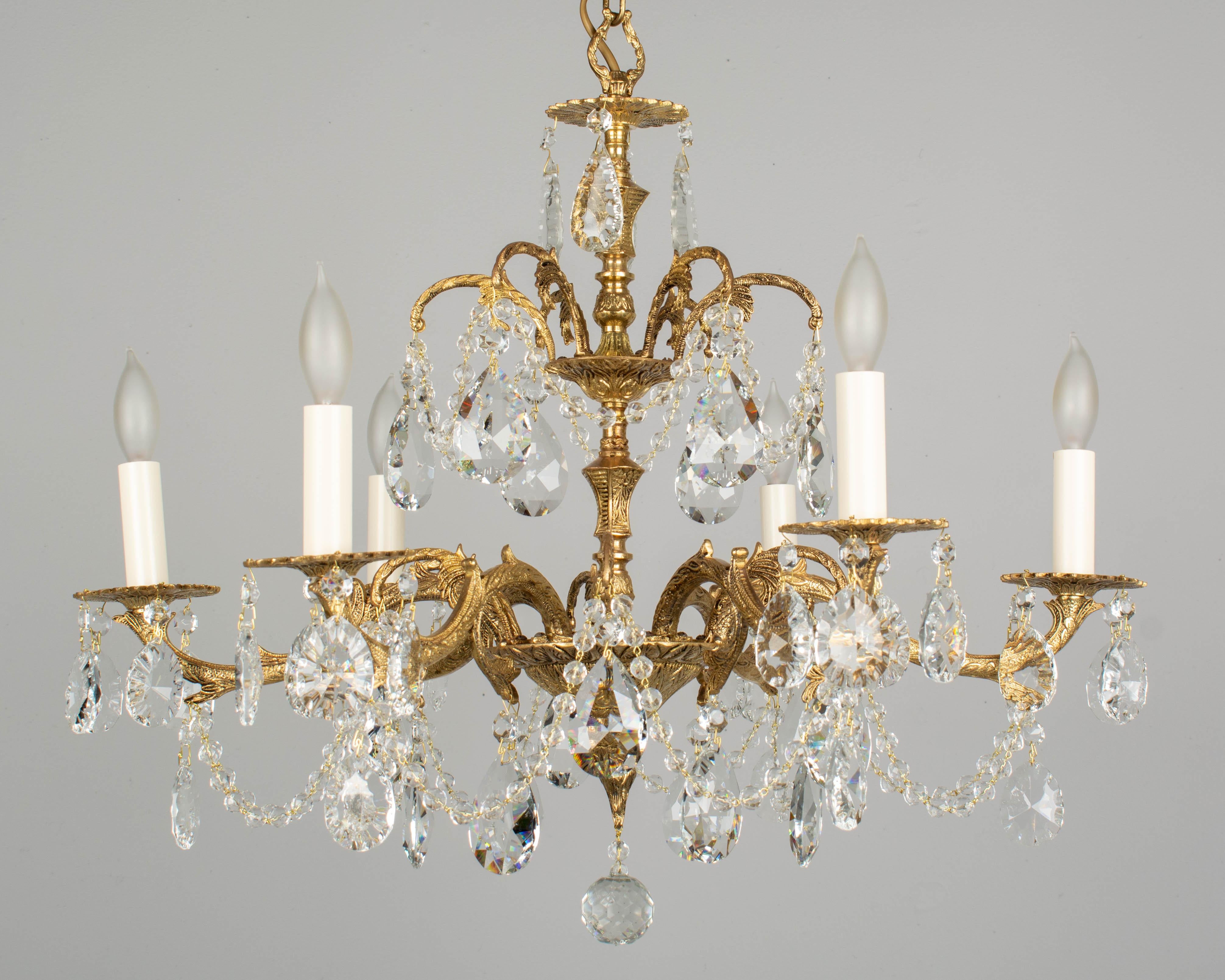 A Spanish six-light crystal chandelier with high quality solid cast brass frame and canopy. The frame is vintage 1950s and the crystals and bead chain are new. Stamped: Made in Spain. Measures: 23