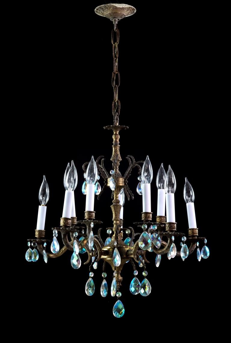 Ornate chandelier done in a brass finish. Features a design of floral detail, dripping with crystals. Made in Spain in the 1940s. This can be seen at our 400 Gilligan St location in Scranton, PA.