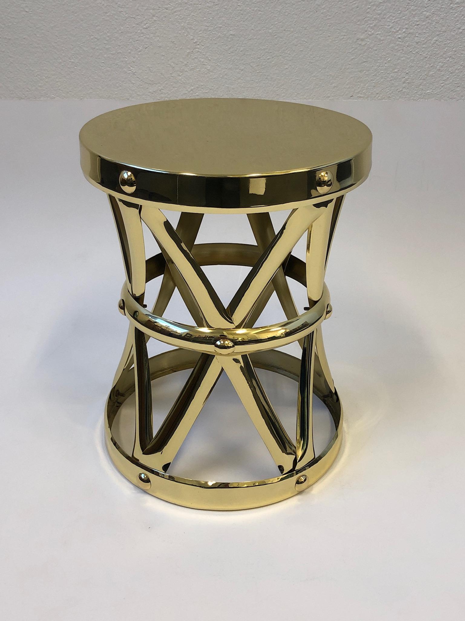 A glamorous Spanish polish brass occasional side table design in the 1970s by Sarreid Ltd. The table has been newly professionally polished. 
Measurements: 12” diameter, 15.25” high.