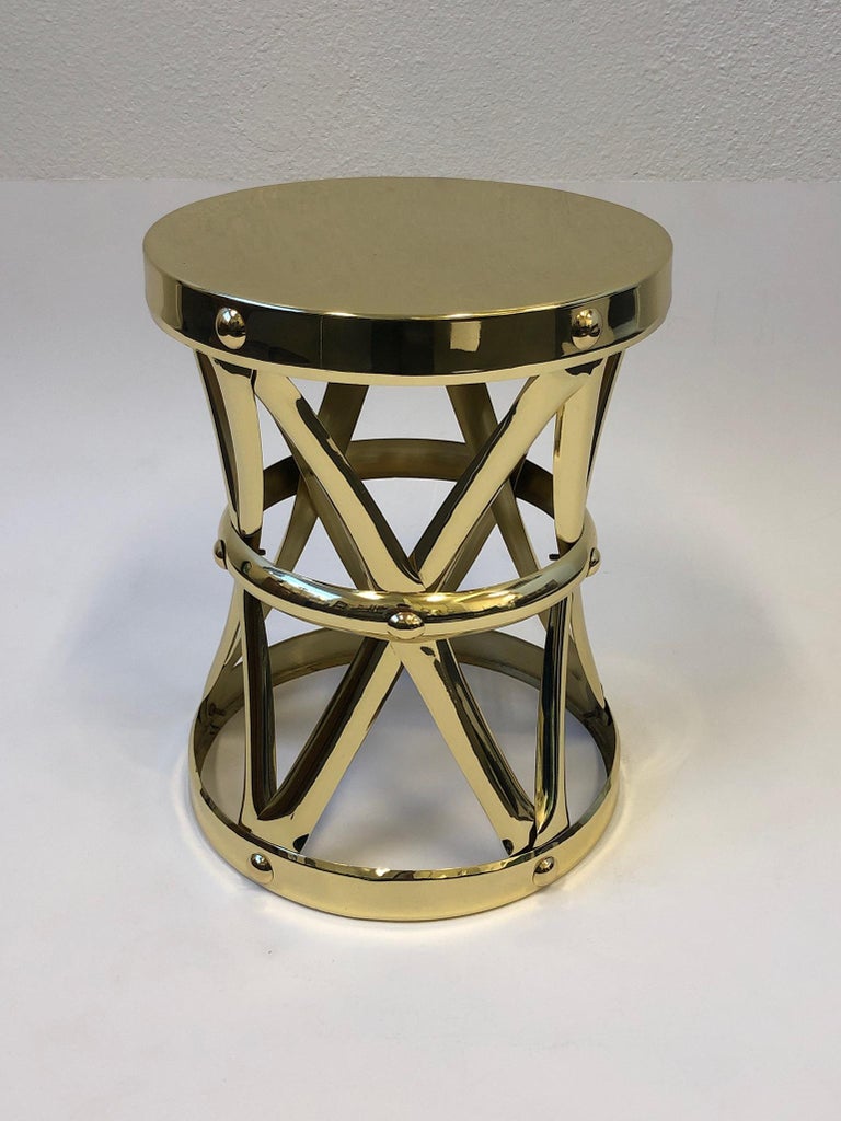 A glamorous Spanish polish brass occasional side table design in the 1970s by Sarreid Ltd. The table has been newly professionally polished. 
Measurements: 12” diameter, 15.25” high.