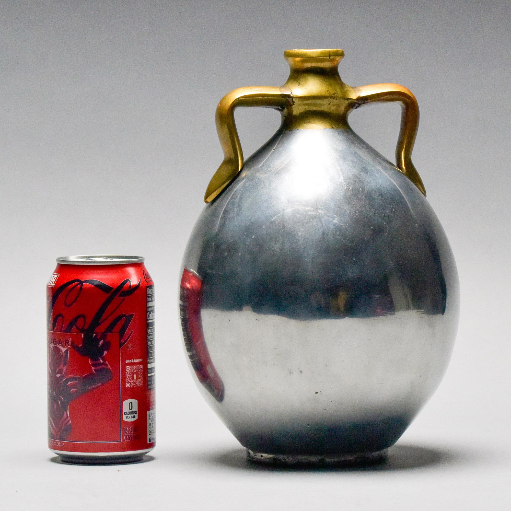 Found in Spain, this brutalist style aluminum and brass jug style vase is attributed to Alfonso Marquez and dates from the 1970s. Vase is 10-1/2” tall and has a diameter just shy of 7” at the fullest point. Sturdy, practical and decorative. At the