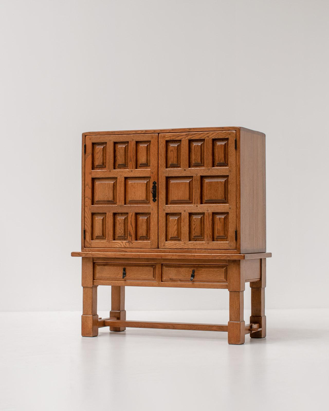 Solid oak Brutalist bar cabinet with wrought iron details, Spain, 1940s.

A timeless piece of Brutalist craftmanship from the 1940s. The sideboard has a beautiful asymmetrical structure on the oak door panels and is finished with elegant patinated
