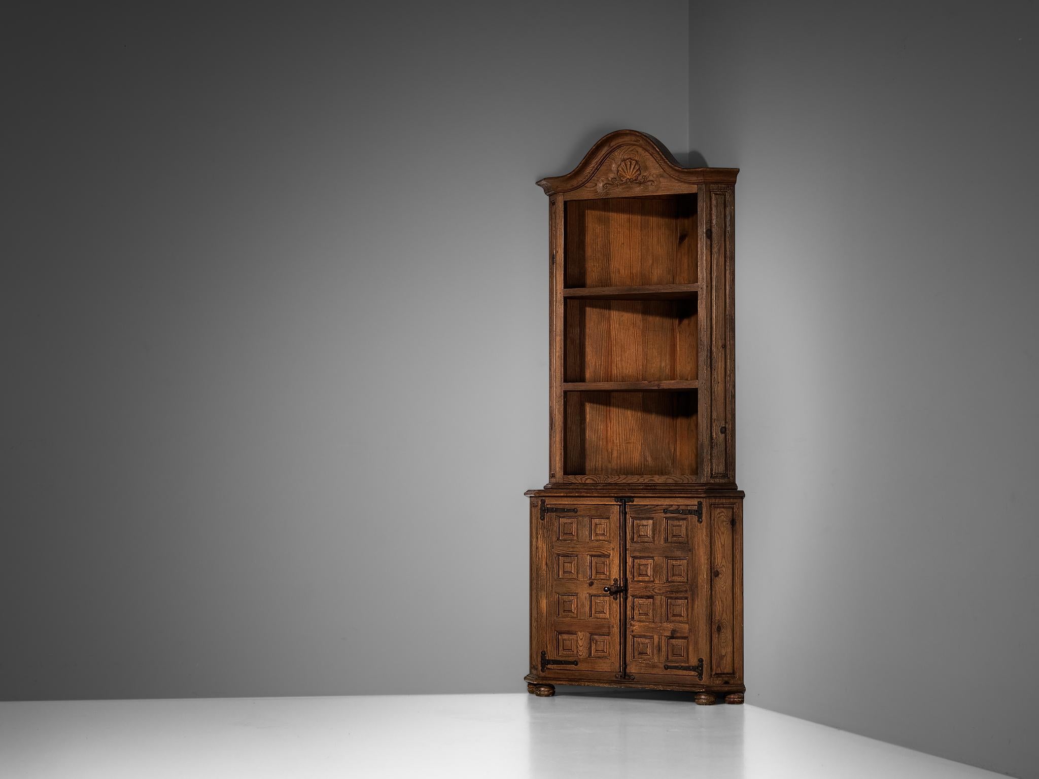 In the manner of Biosca, tall corner cabinet, stained pine, iron, Spain, 1970s 

Outstanding Spanish cabinet that shows well-known traits of Biosca in an architectural way. The door panels feature a relief surface of graphic carved squares. This is