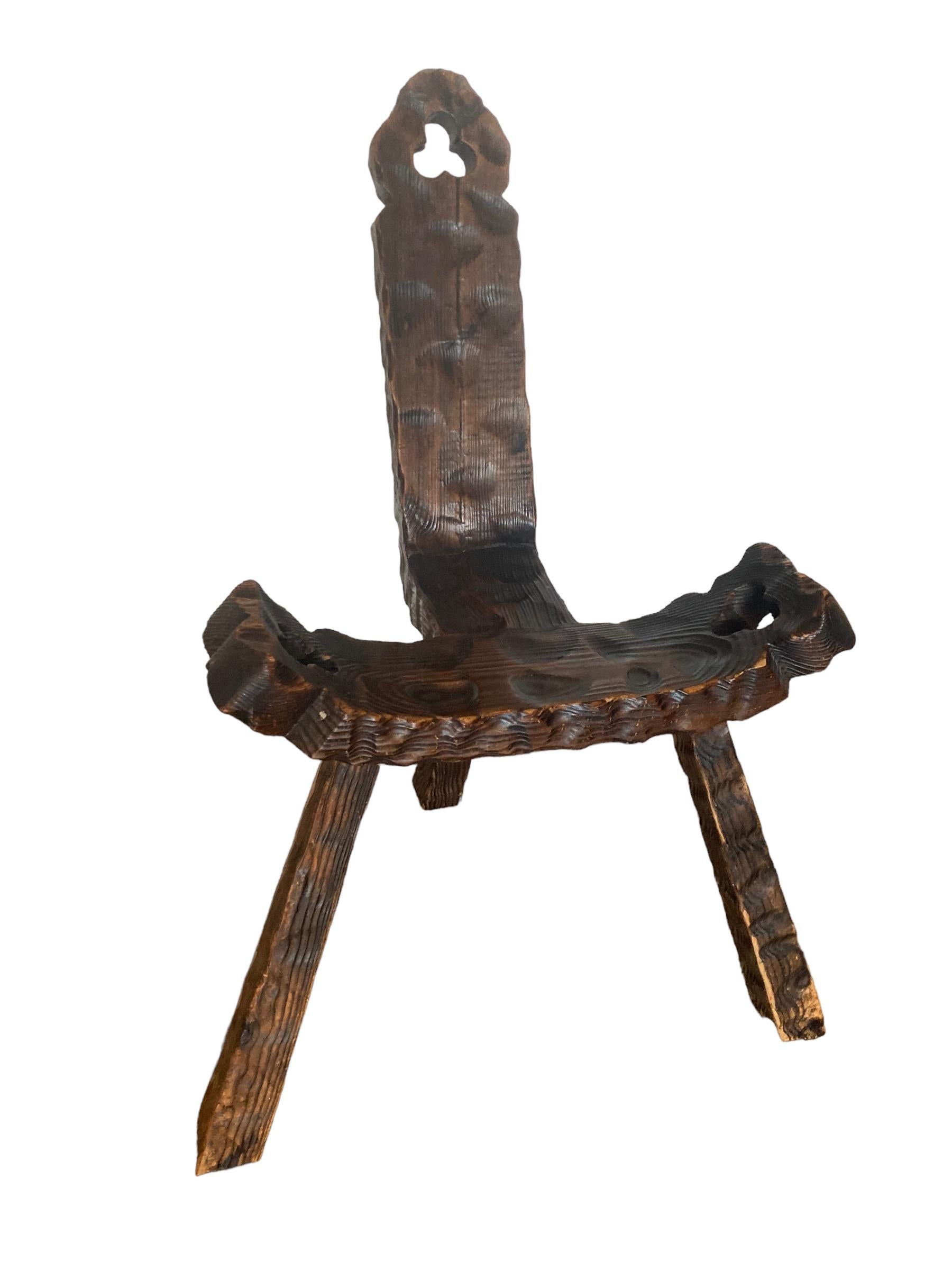 Spanish Brutalist or Primitve Mid Century Tri Legged Chair. This chair offers more than a visual appeal, these have a historic use as a birthing chair. Handcrafted, solid wood this chair boasts exceptional craftmanship with its simplistic