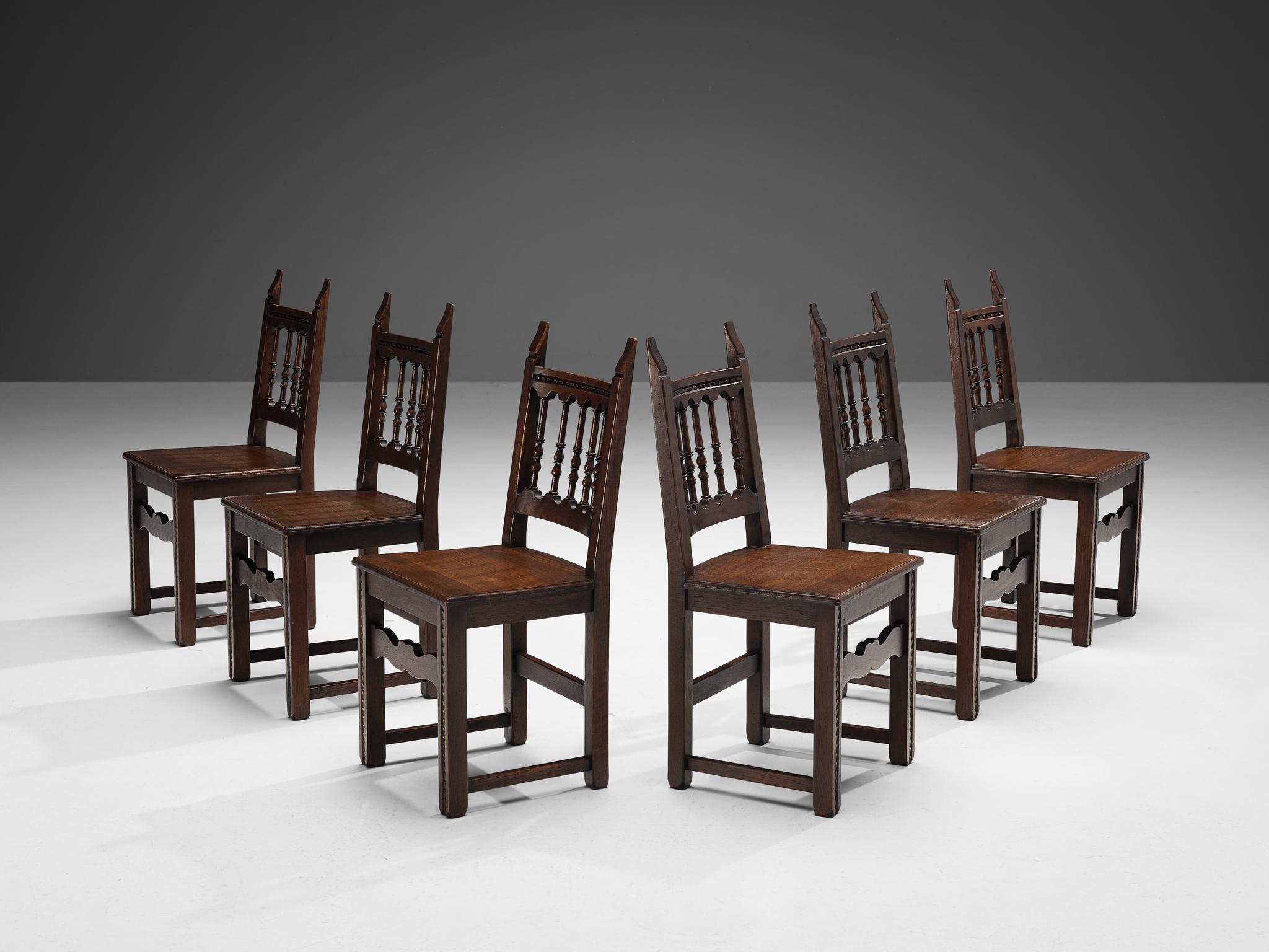 Set of six dining chairs, oak, Spain, 1950s.

These dining chairs of Spanish origin have a rustic yet distinctive design. The wooden frame is beautifully carved, showing decorative spindles that form the backrest. The overall frame embodies clear