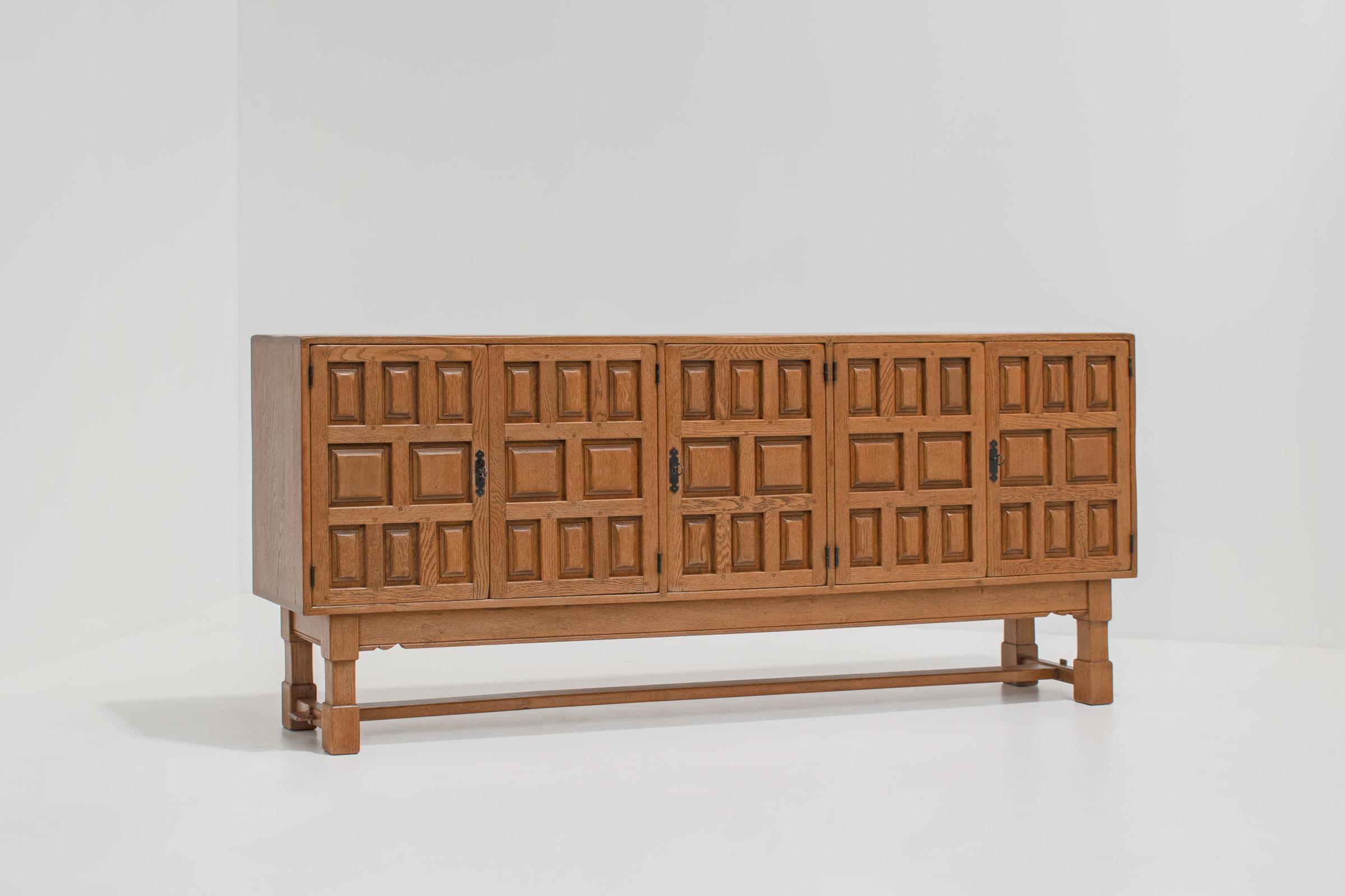 Solid oak Brutalist sideboard with wrought iron details, Spain, 1940s.

A timeless piece of brutalist craftmanship from the 1940s. The sideboard has a beautiful asymmetrical structure on the oak door panels and is finished with elegant patinated