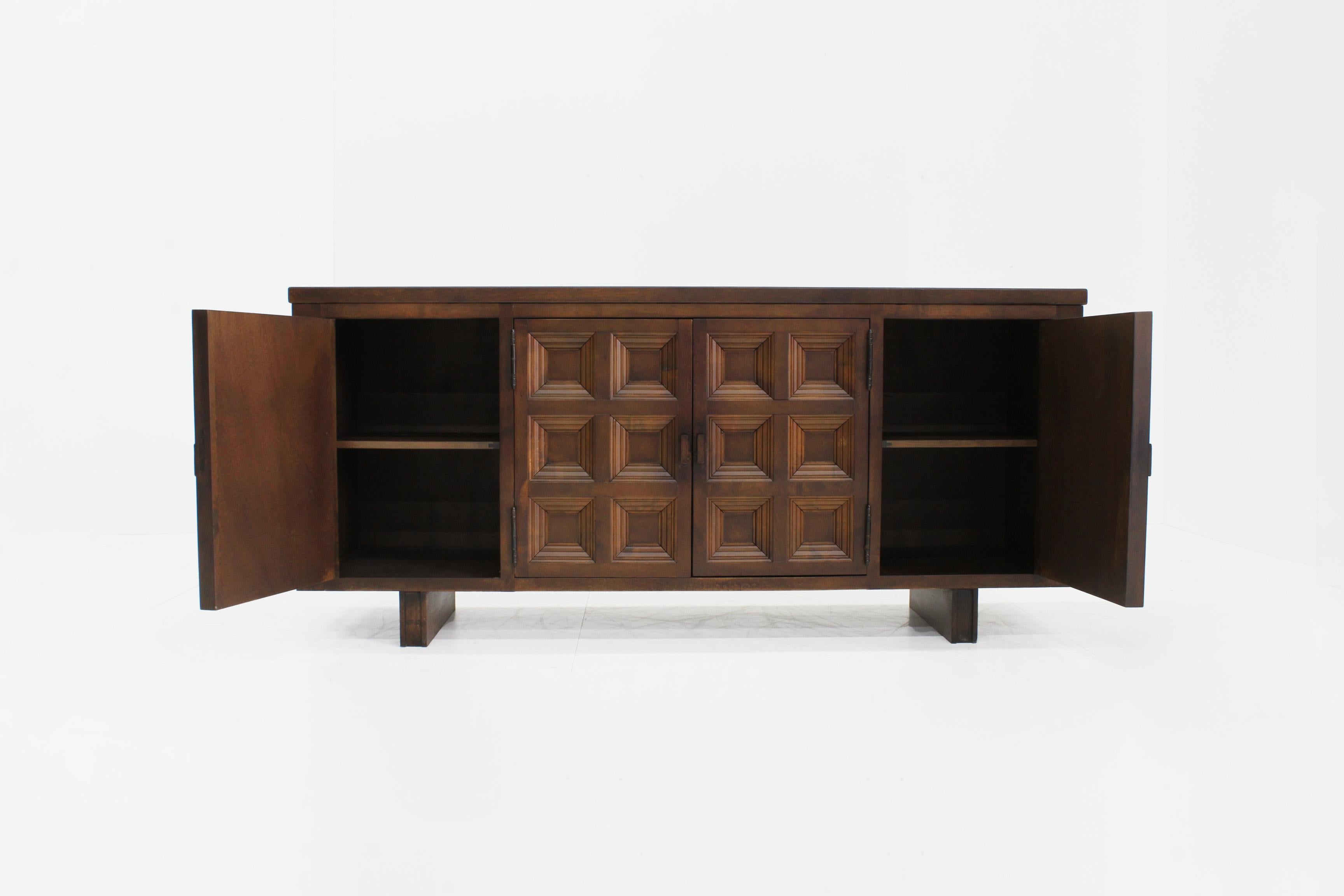 Spanish Brutalist Sideboard in Solid Walnut
 
Spanish Brutalist Sideboard in solid walnut wood from the 1960s. Beautifully designed with graphical squares on the front as well as the sides of the credenza. 
 
Plenty of storage space with 4 drawers