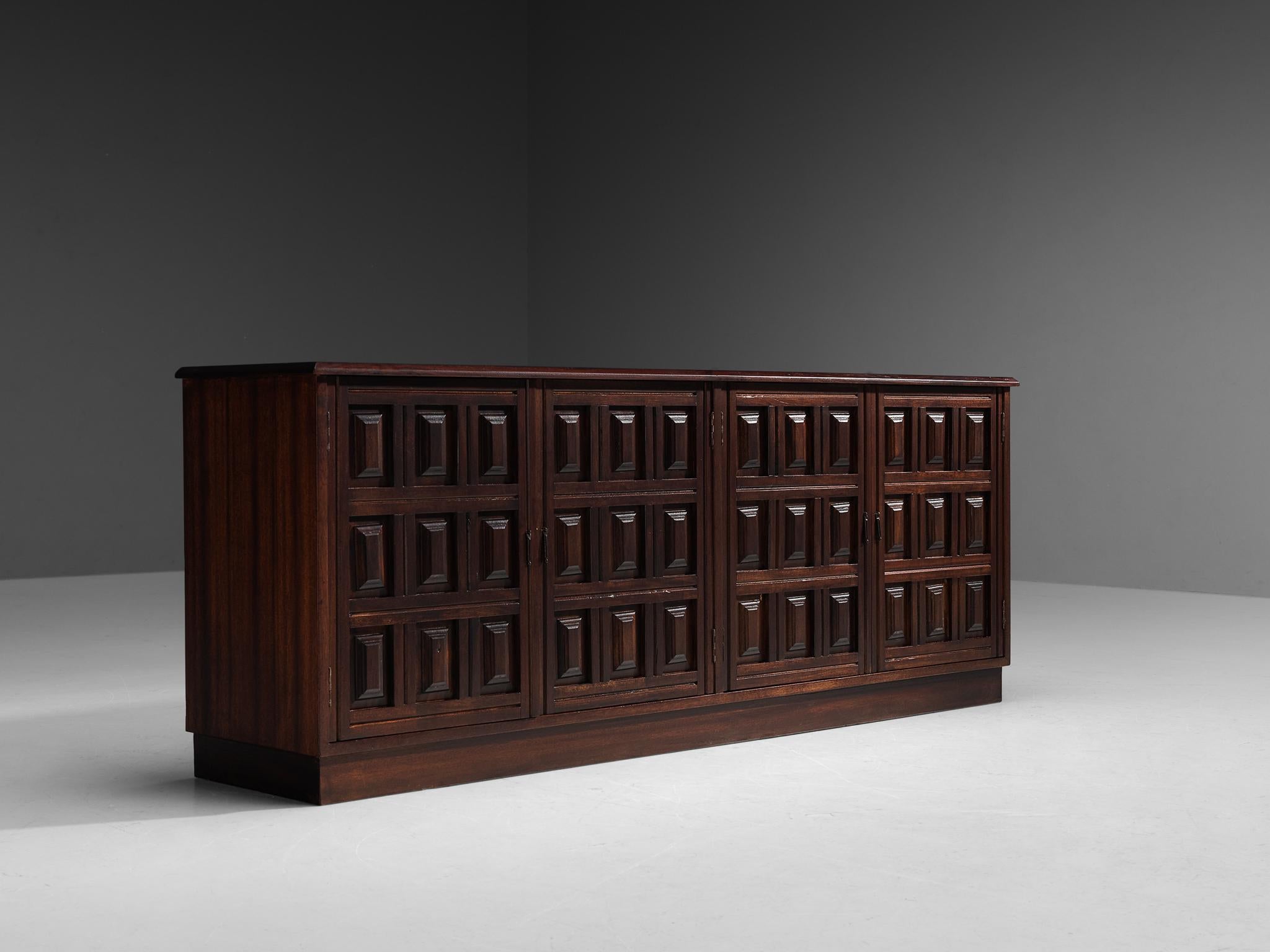 Sideboard, mahogany, Spain, 1970s.

Robust and rich Spanish sideboard in red stained mahogany. The sideboard has four doors with great woodwork in rectangular pattern with small metal bar-handles for opening them. The interior offers plenty of