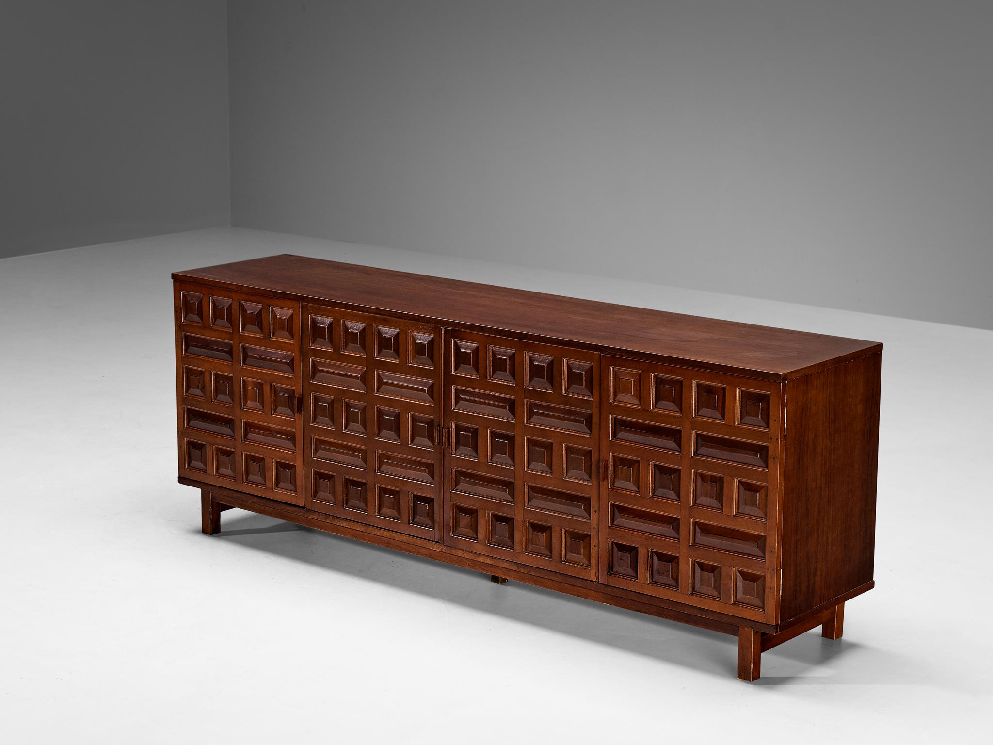 Sideboard, stained mahogany, Spain, 1970s.

This cabinet originates from Spain and shows the decorative characteristics of the 16th century Castilian furniture design. The carved geometric shapes on the door panels immediately catch the eye and