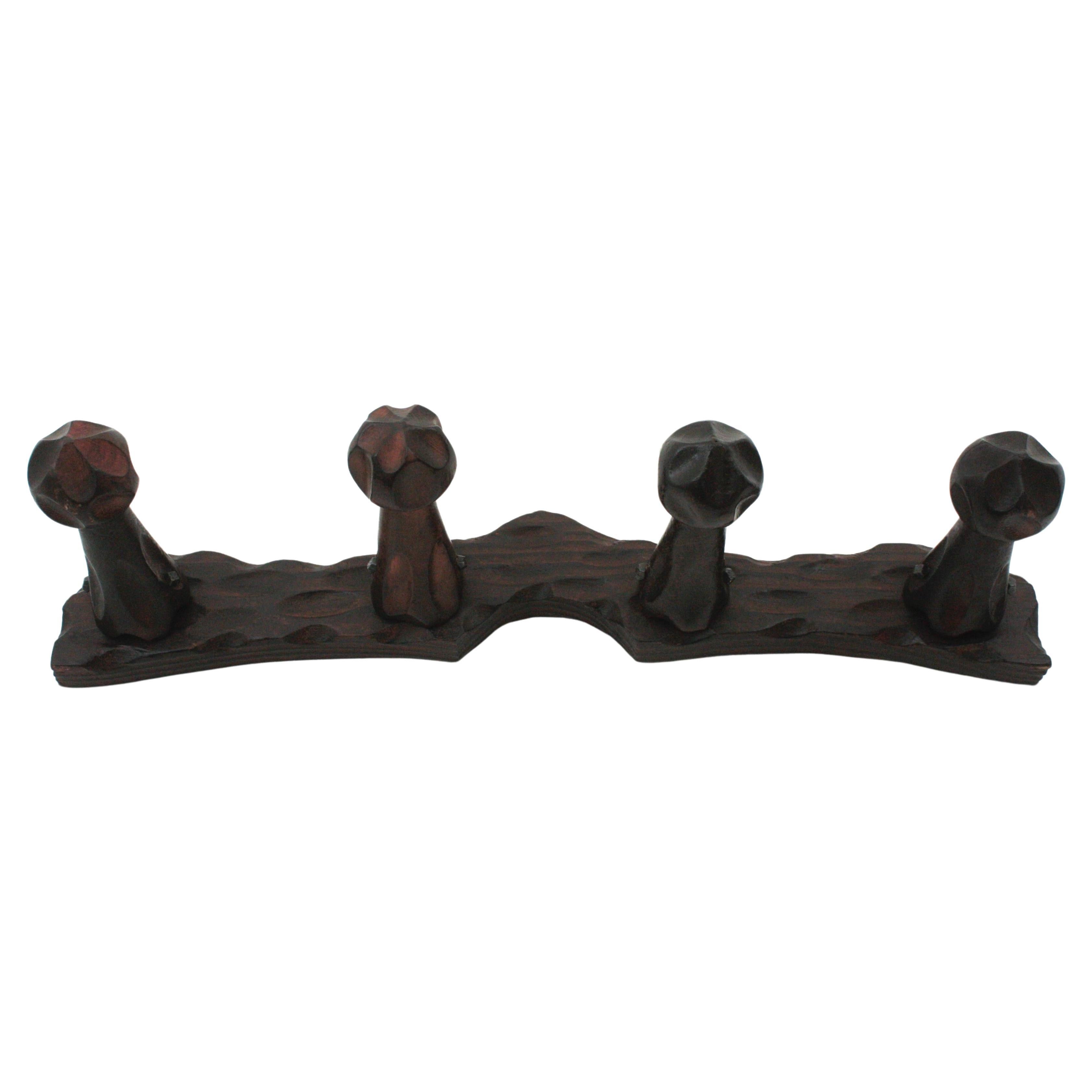 Handcarved pine wood wall coat rack, 4 hangers, Spain, 1940s.
This eye-catching coat rack was designed in the style of Brutalism with 4 Free from carved hangers.
Made of solid wood. Iron nails accents.
To be used a wall coat rack or hat rack.
It