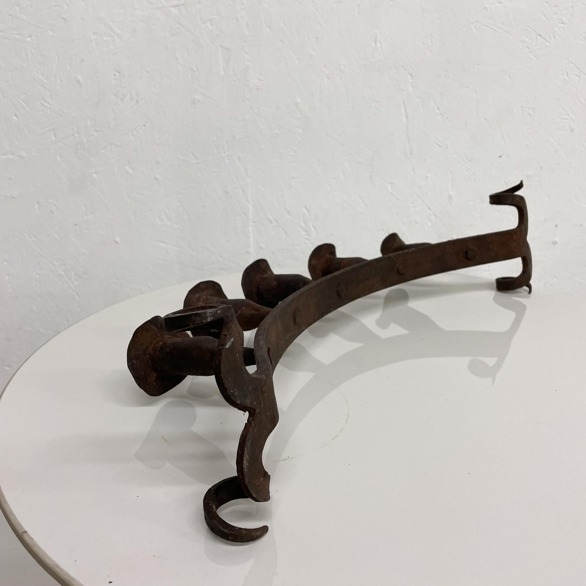 Antique Candle Holder Spanish Colonial 5 Arm Candelabra Candle Holder Rustic Scroll 
Forged Patinated Metal Iron
20.5 W x 7.5 Tall x 4.63 D inches
Unmarked
Antique Condition Vintage with Patina present Unrestored.
See our images provided. 


