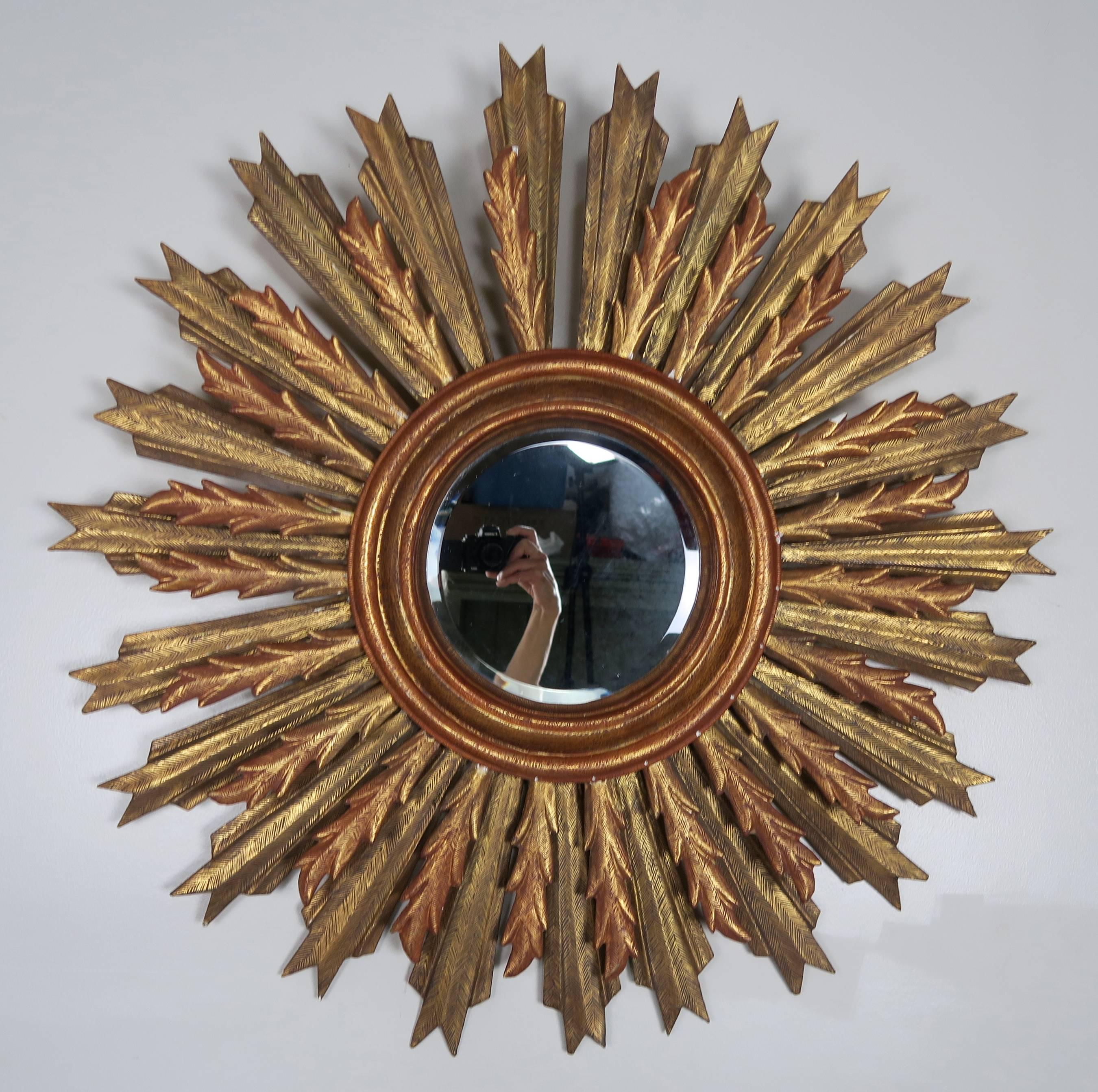 Spanish carved giltwood sunburst mirror with beveled glass.
 