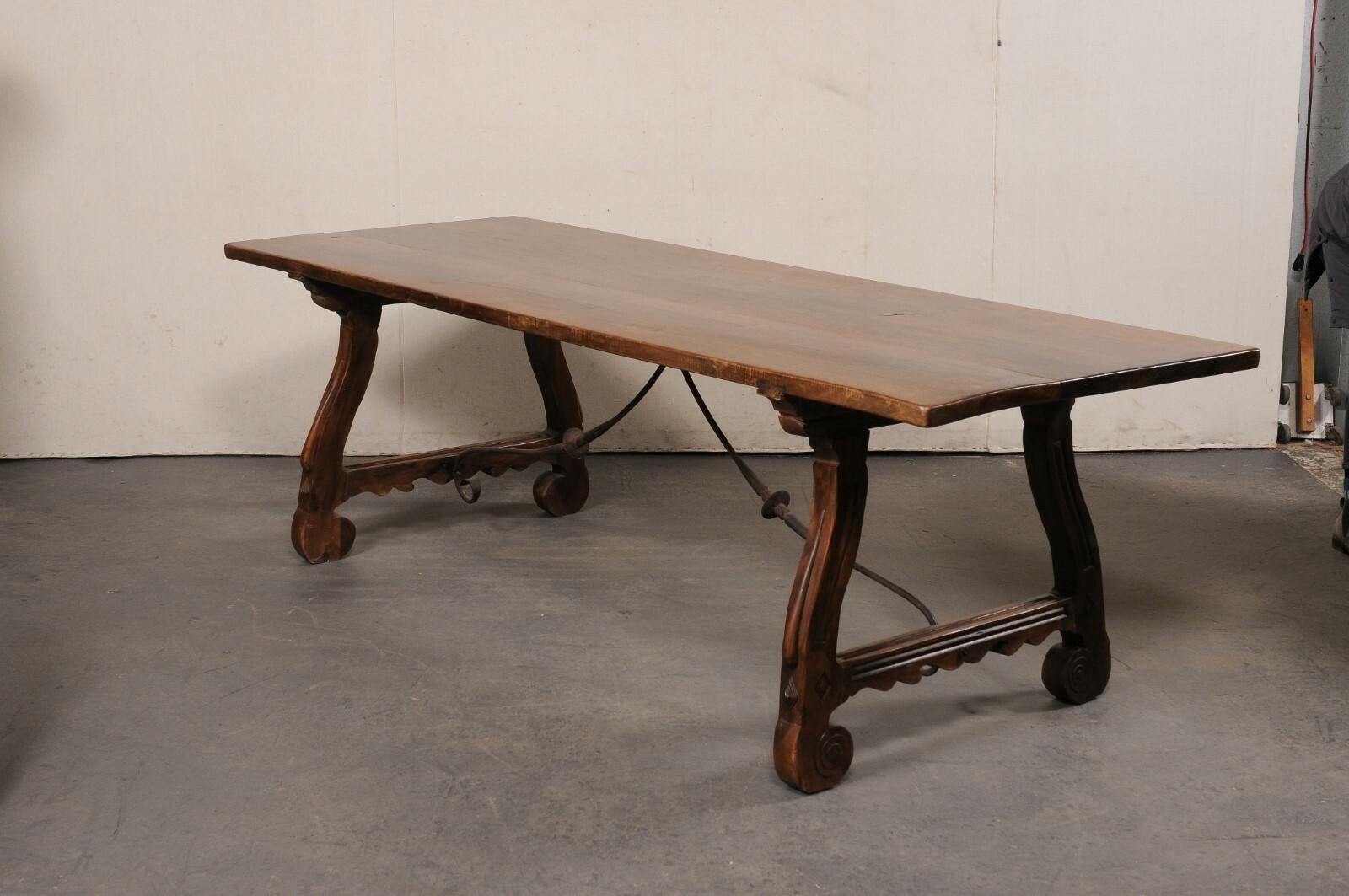 20th Century Spanish Carved Walnut Wood Trestle-Leg Table w/Forged Iron Stretcher, 8+ Ft Long For Sale