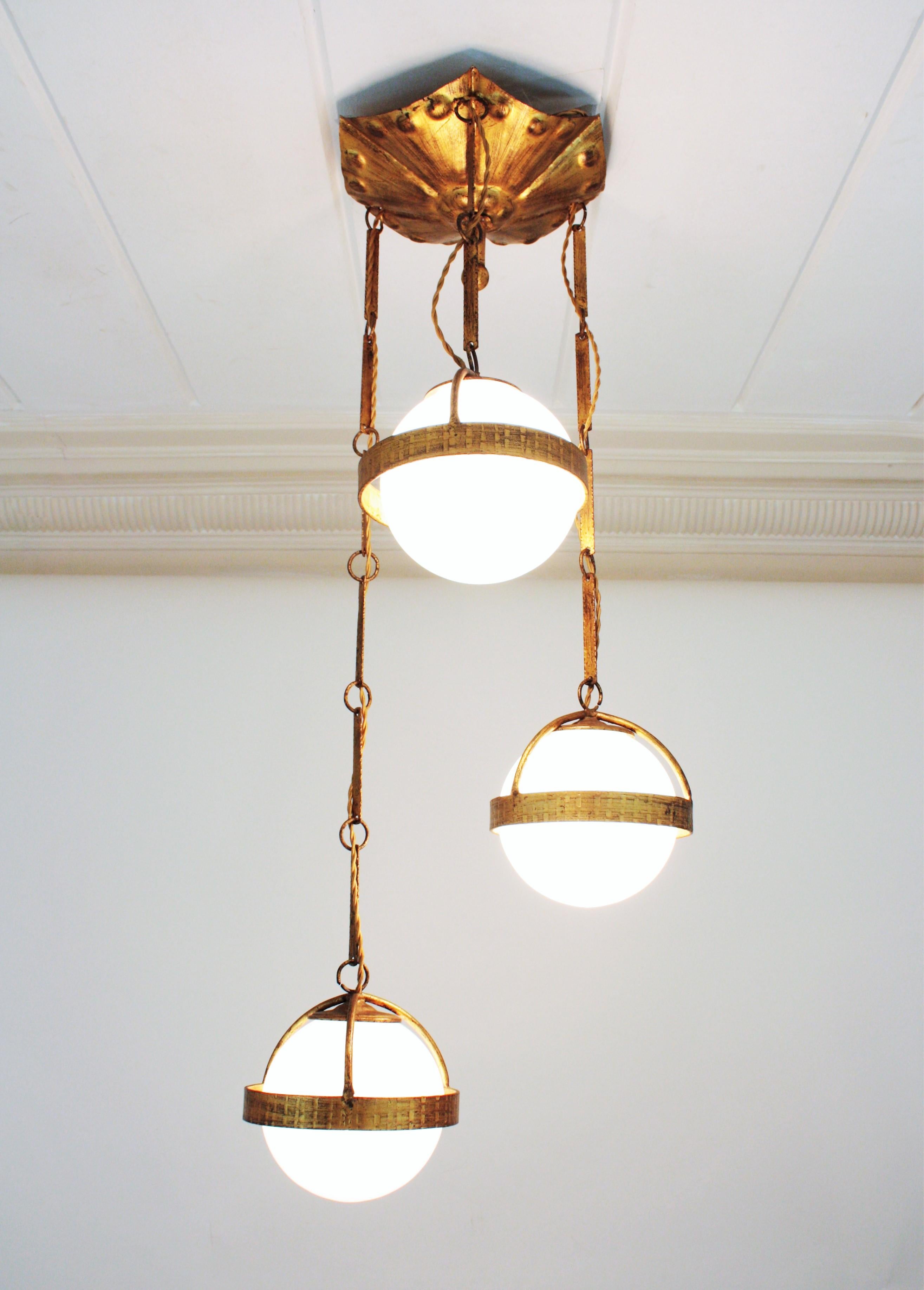 Mid-Century Modern Spanish Cascade Chandelier / Pendant in Gilt Wrought Iron with Glass Globes