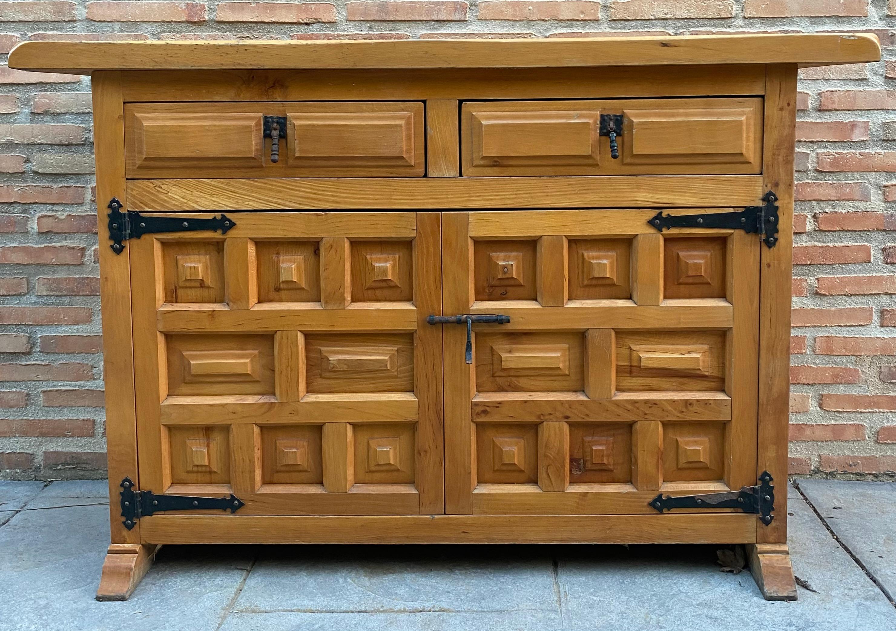 20th century Catalan Spanish carved walnut chest of drawers, highboy or console Country Provincial Chinffoniere was fashioned from solid walnut and features two drawers and two doors carved with charming detail and fitted with unusually intricate