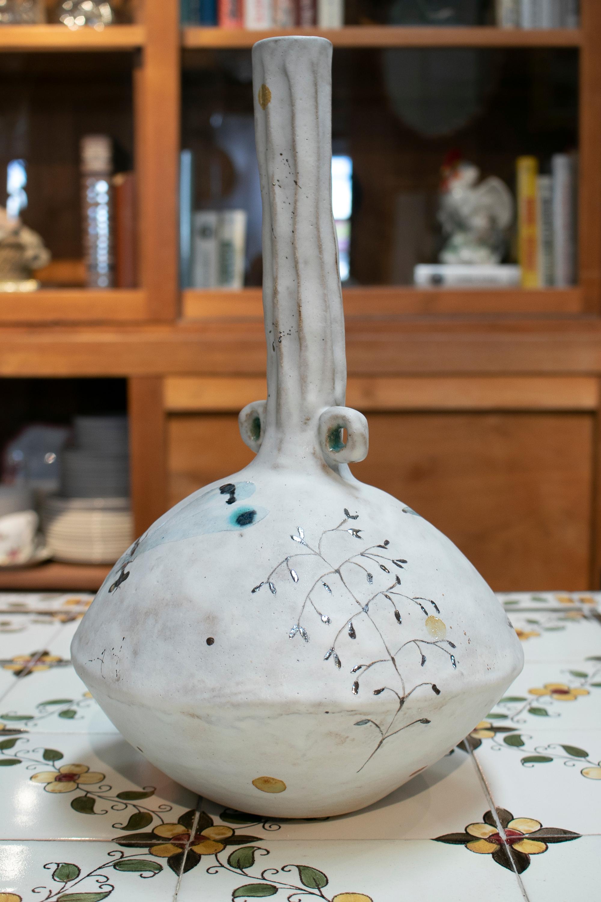 Spanish ceramic vase decorated with hand painted animal motifs.