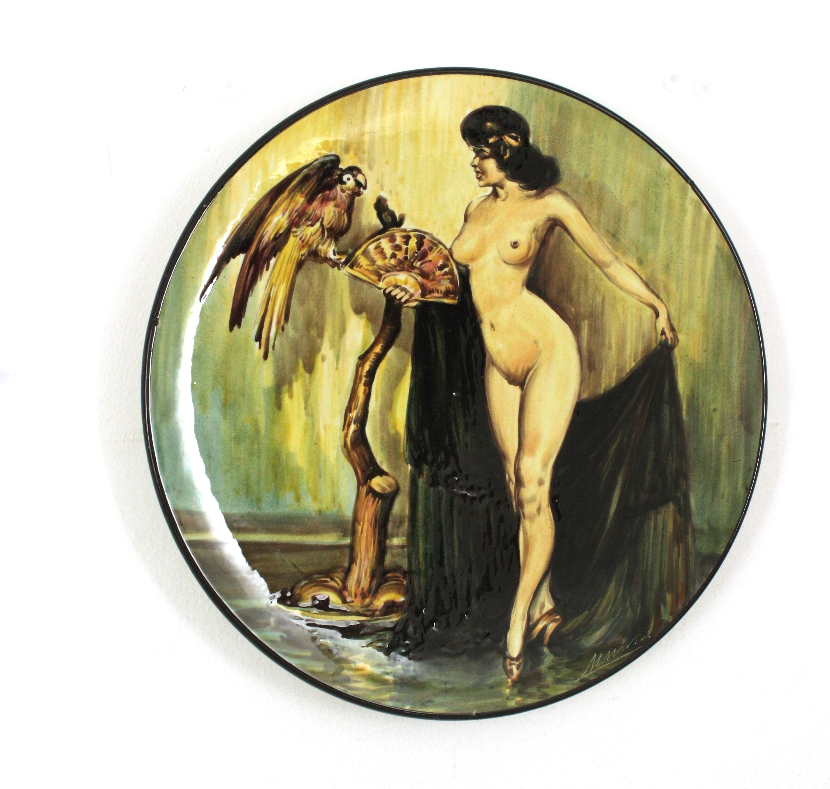Hand-painted nude woman ceramic wall plate, Spain, 1950s
Gipsy naked woman with parrot
Signed M Marco at bottom right side
Marked at the back part: 'Gitana Desnuda'- I.Zuloaga- Pintado a mano, España.

This hand-painted ceramic plate is inspired on
