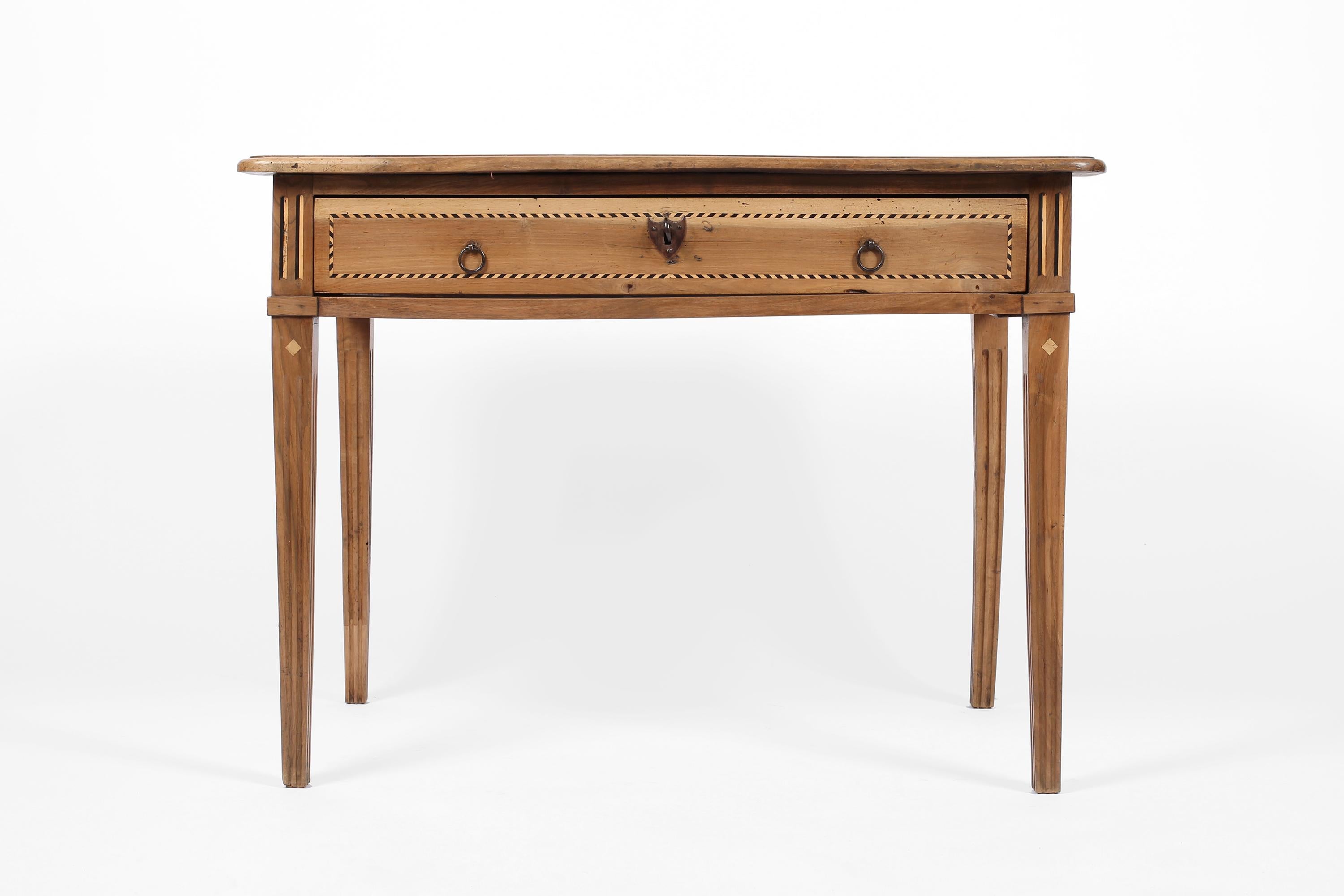 A fine Charles IV walnut writing desk/side table with decorative inlaid marquetry work in blonde wood and ebony. Featuring forged iron hardware to the single large drawer, with working original lock and key. Spanish, c. 1790.
