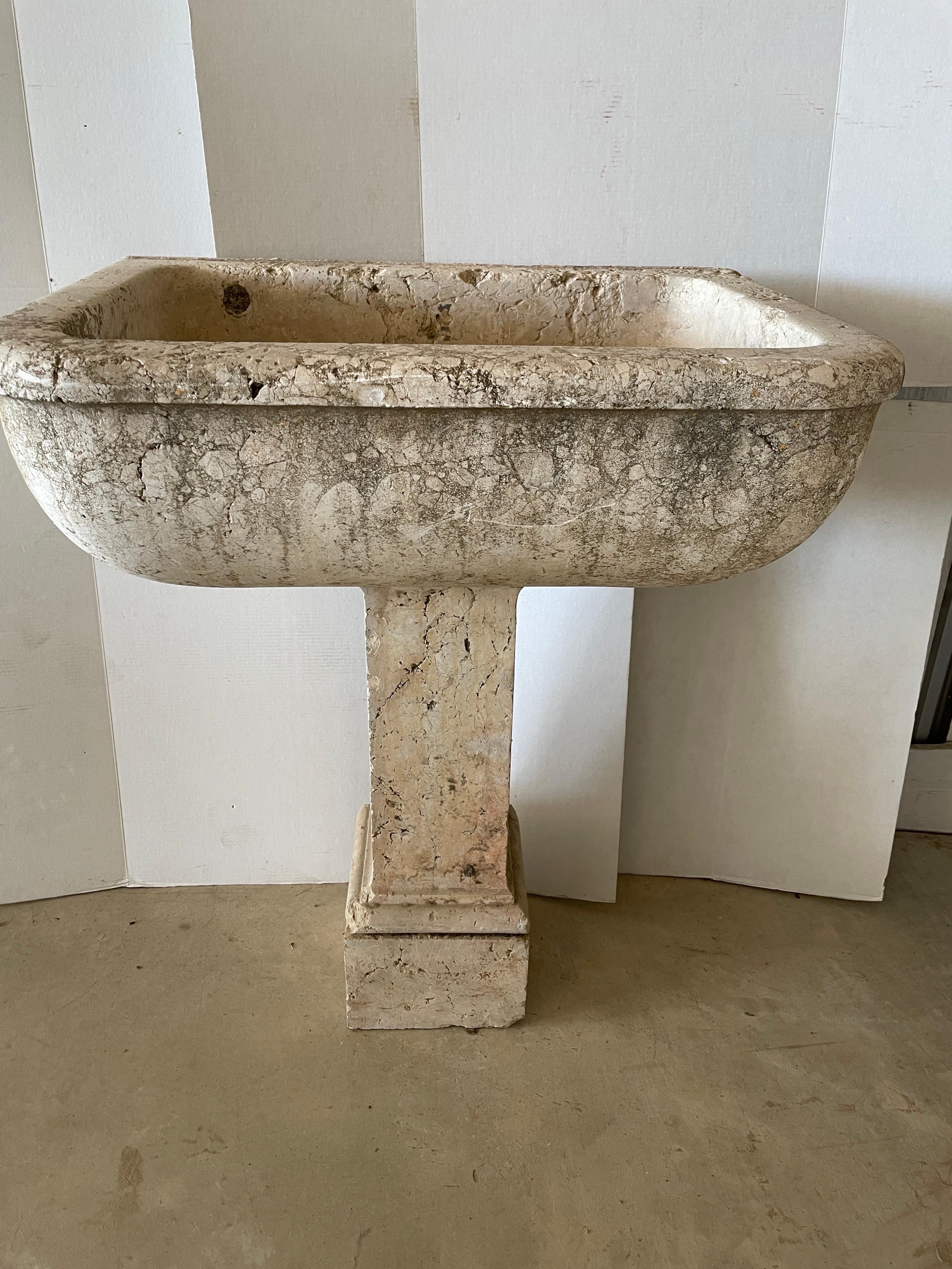This is a large scale Spanish 18th century fountain sink from the Tarragona region of Spain. The cream and light pink veins in this marble is typical from that area. It's great outdoors or inside for a sink in a large powder room or anywhere one is