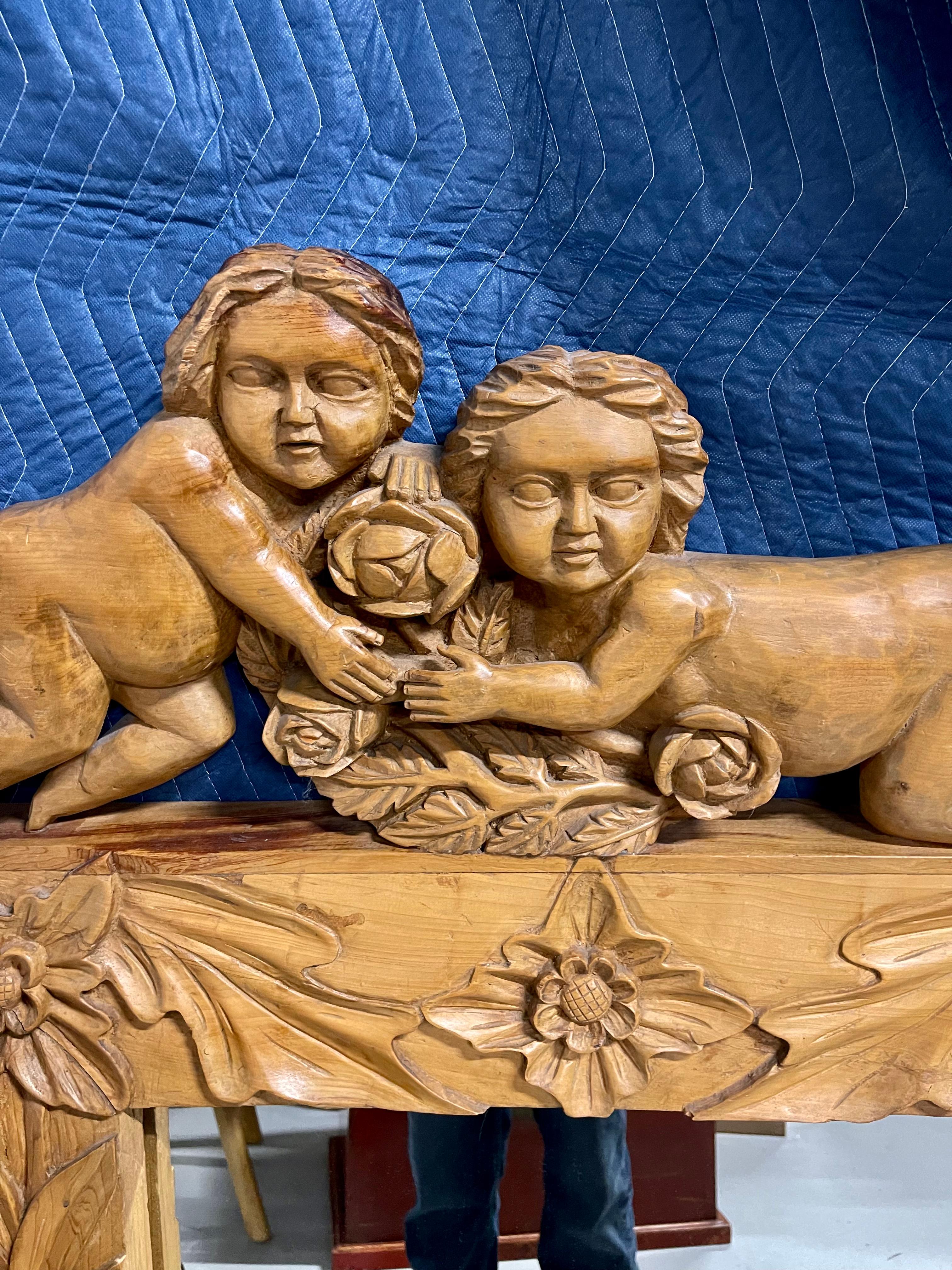 Wonderful early Spanish Colonial mirror with carved cherubs or putti on top. Nicely carved floral detail. Great detail and form. In good age appropriate condition with some age cracks and wear. This Mirror along with an early Spanish Colonial table