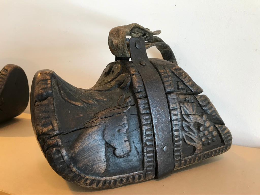 Fantastic pair of 18th-19th century South American carved wooden stirrups. Known as estribos, each are carved from a solid block of wood. Decorated with wonderful carvings of horse heads and grape vines, these are truly charming pieces of Folk Art.