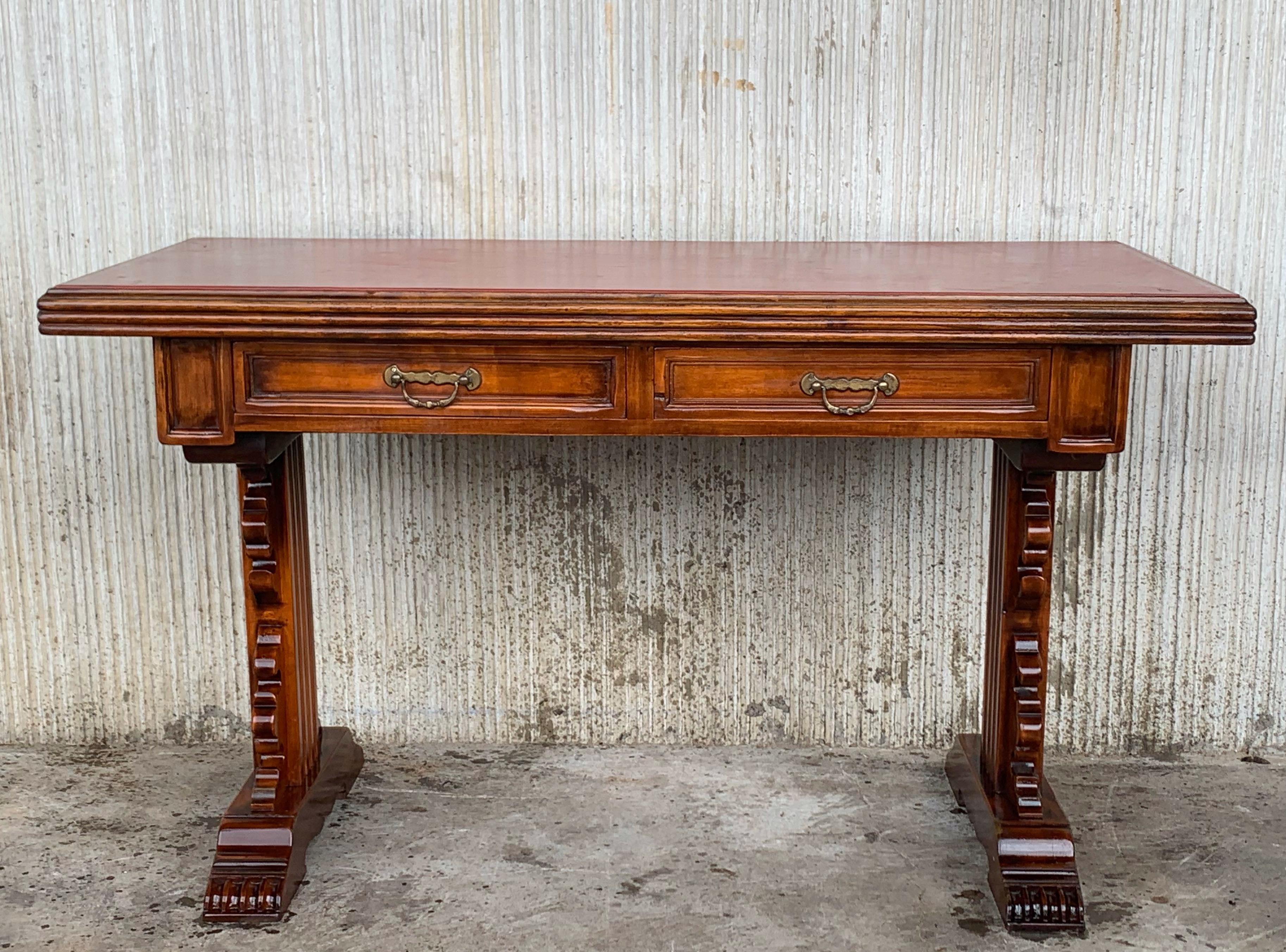 Spanish colonial desk or console table with two drawers signed by Valentí
This piece has a two-pedestal legs with an awesome carved. The top has a red leather.
