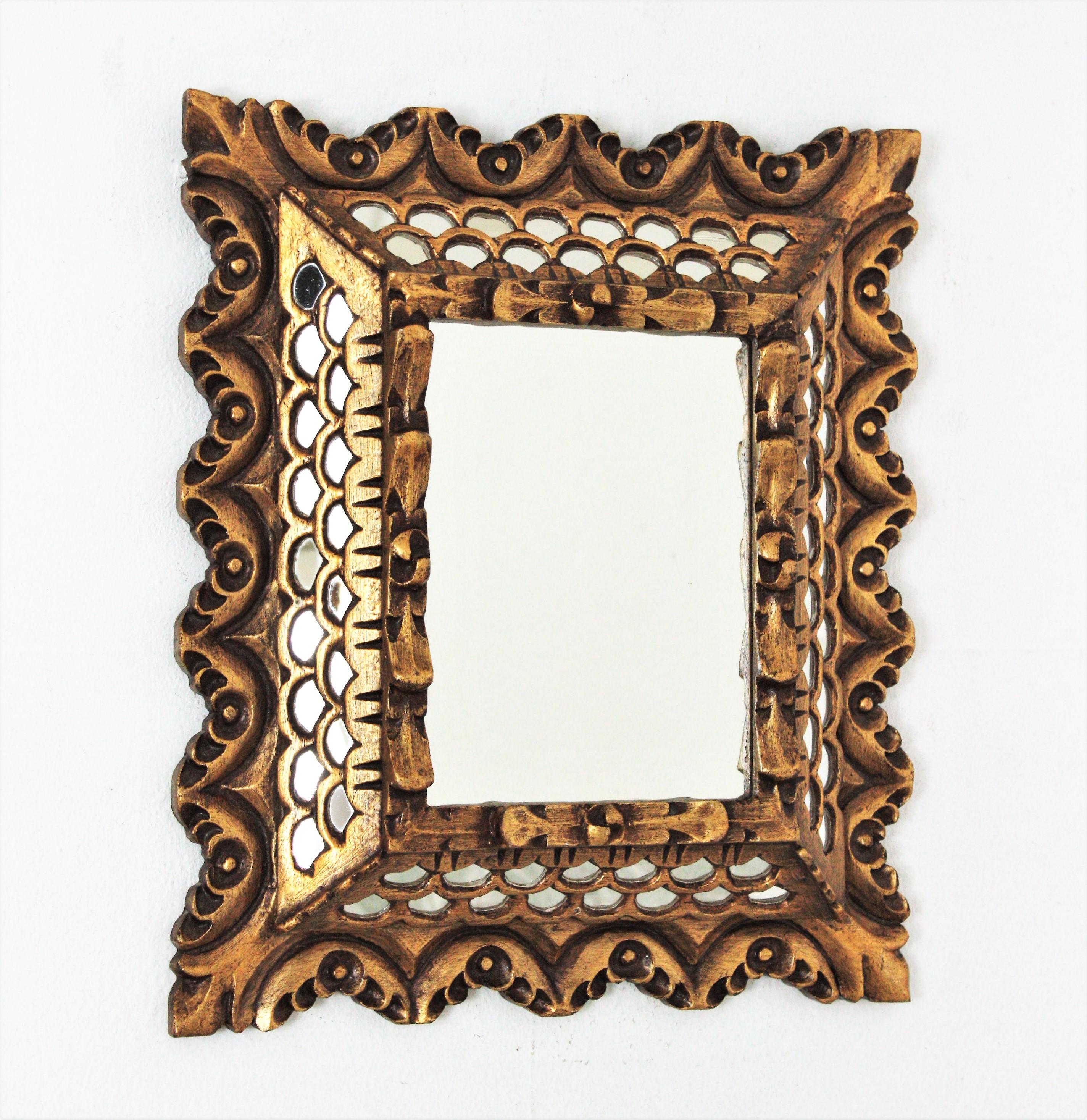 Spanish Colonial style gilt wood scalloped rectangular mirror with mirror insets in the frame, 1960s
This lovely wall mirror has two layers of mirrors surrounding the central glass, scalloped edges and carving decorative details thorought.
Original