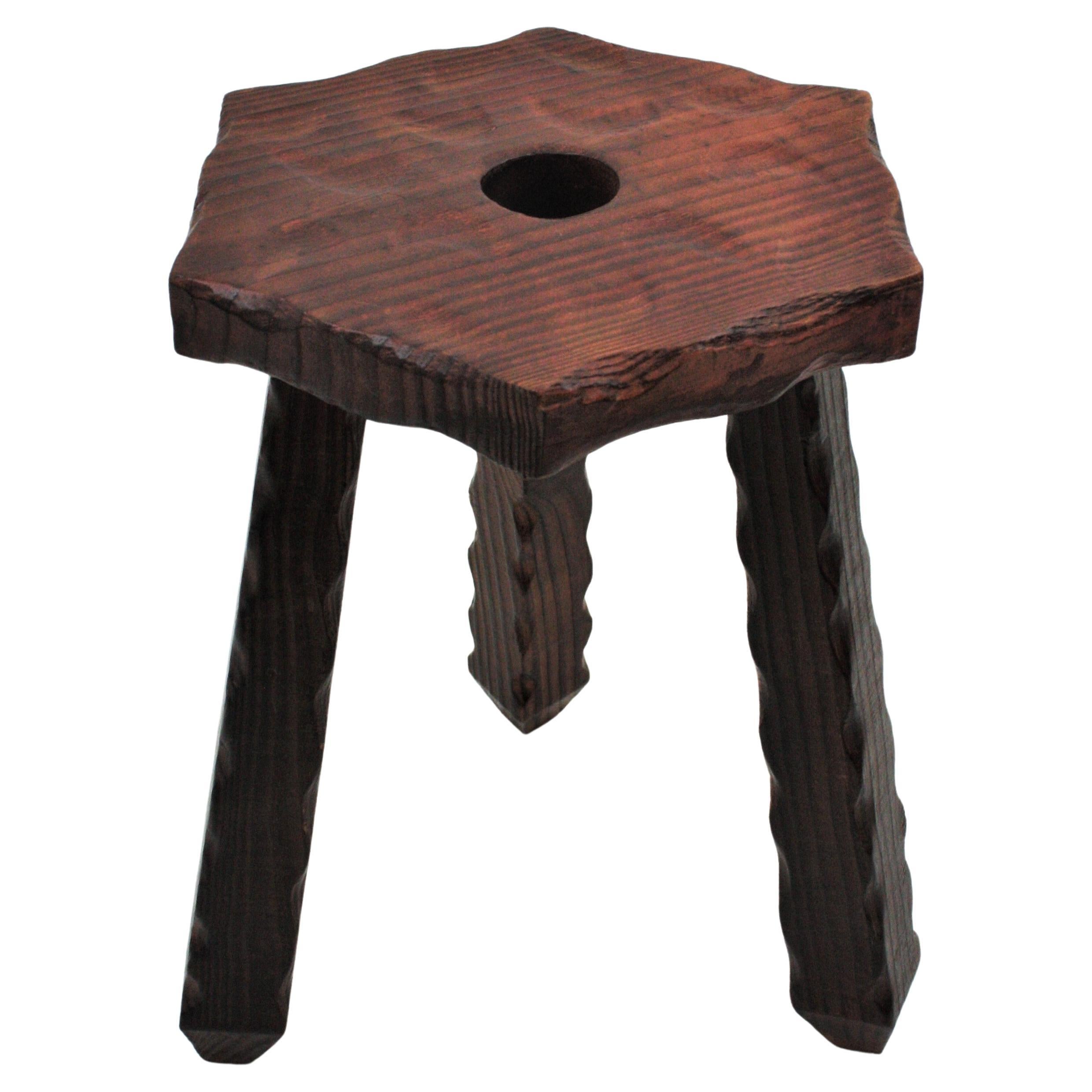 Hexagonal Wooden Tripod Stool, Spain, 1940s
The top has scalloped details at the edge and the top has decorative carvings and a hole at the central part. 
This stool has a rustic finish and spanish colonial accents.
It will be a nice a addition to a